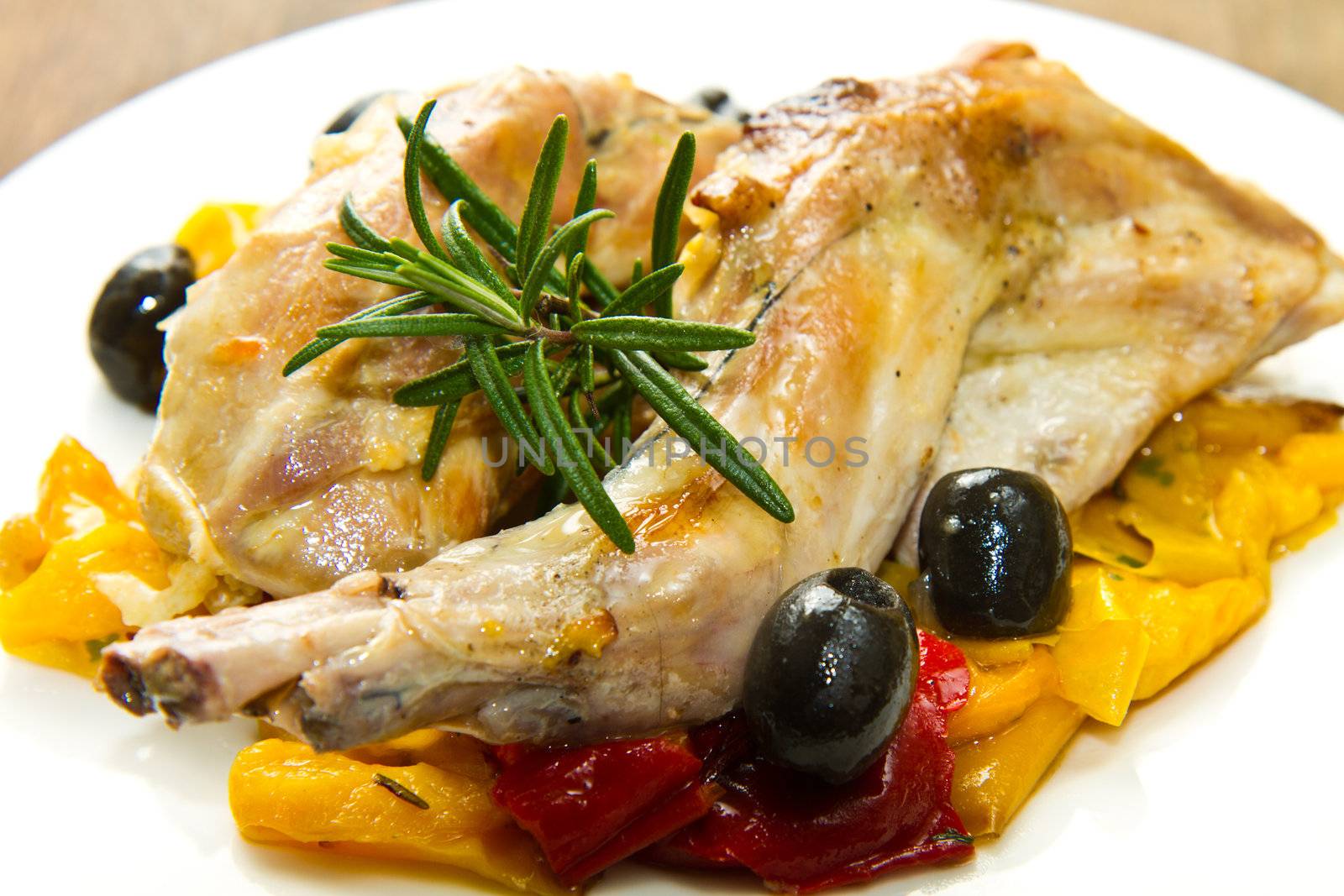 Baked rabbit with olives and pepper