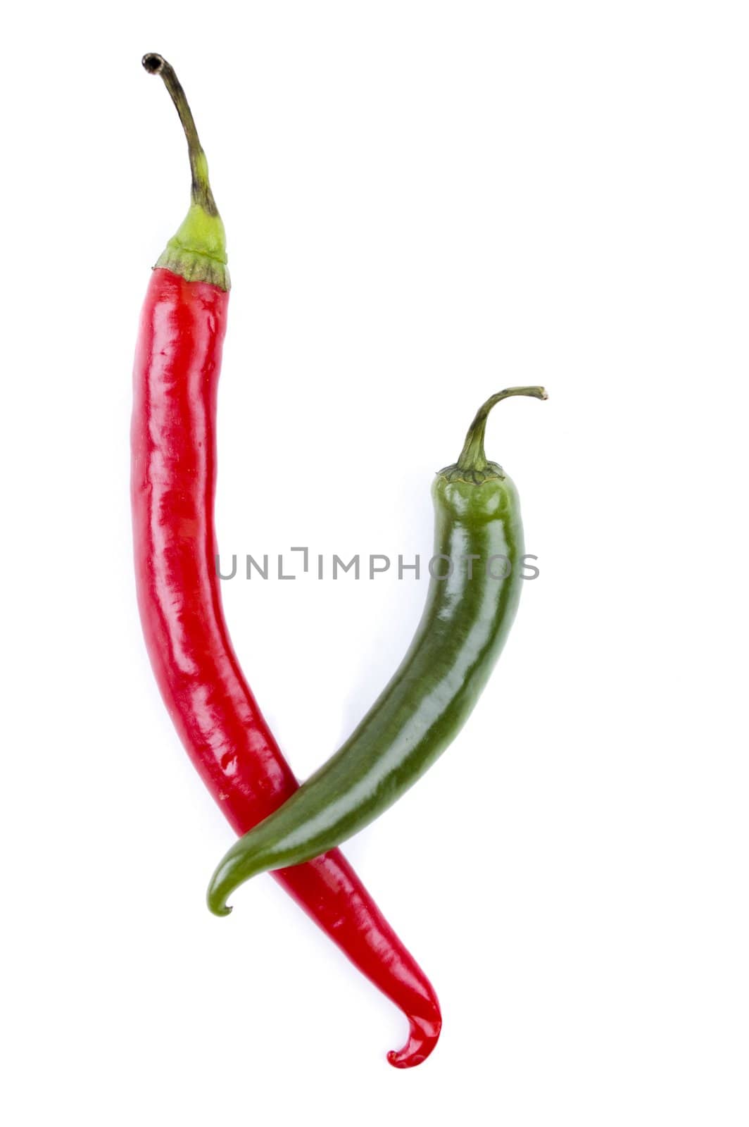 Red and green chili peppers on white background by Triphka