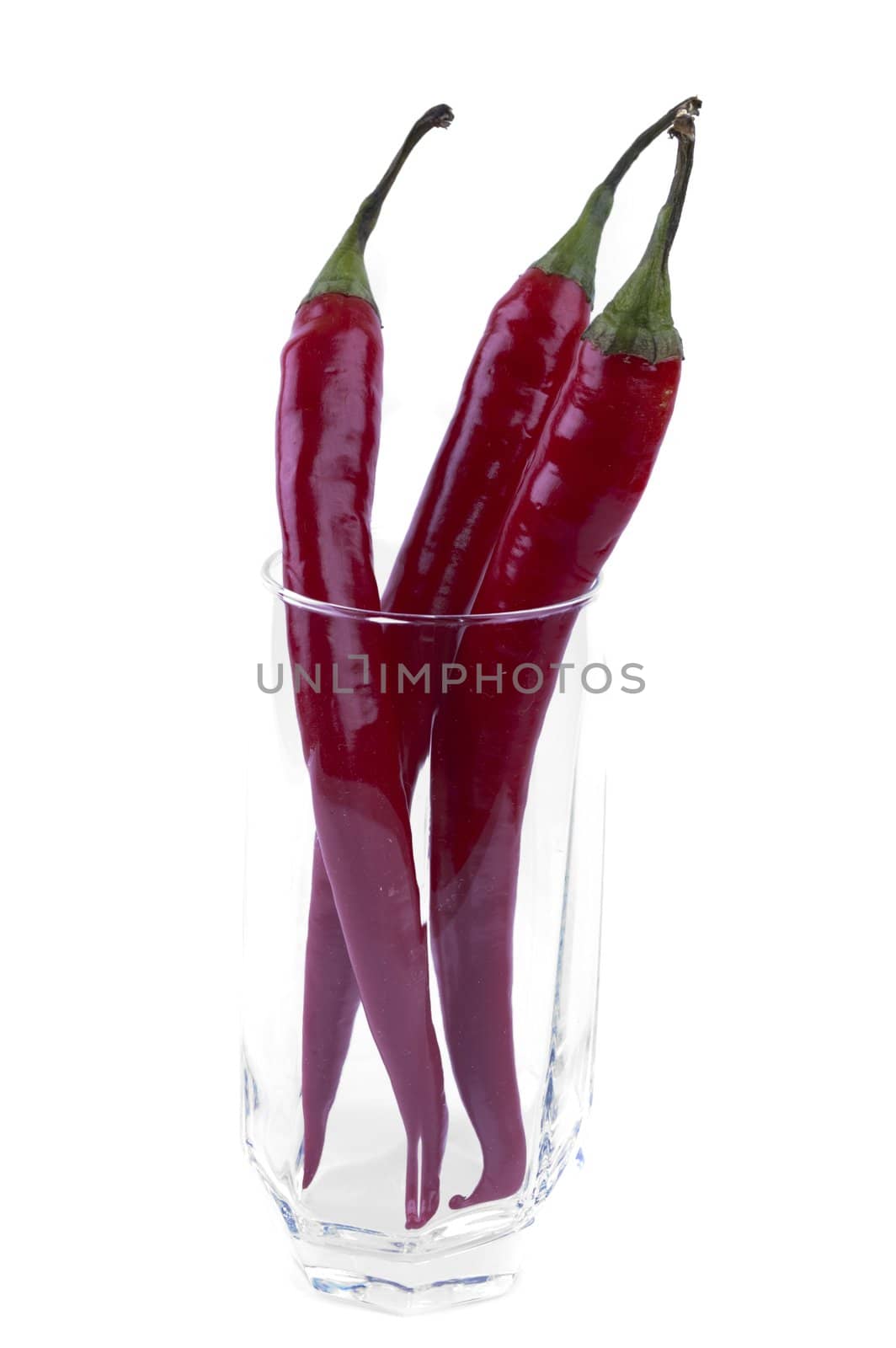 isolated pack of red chili peppers in a glass by Triphka