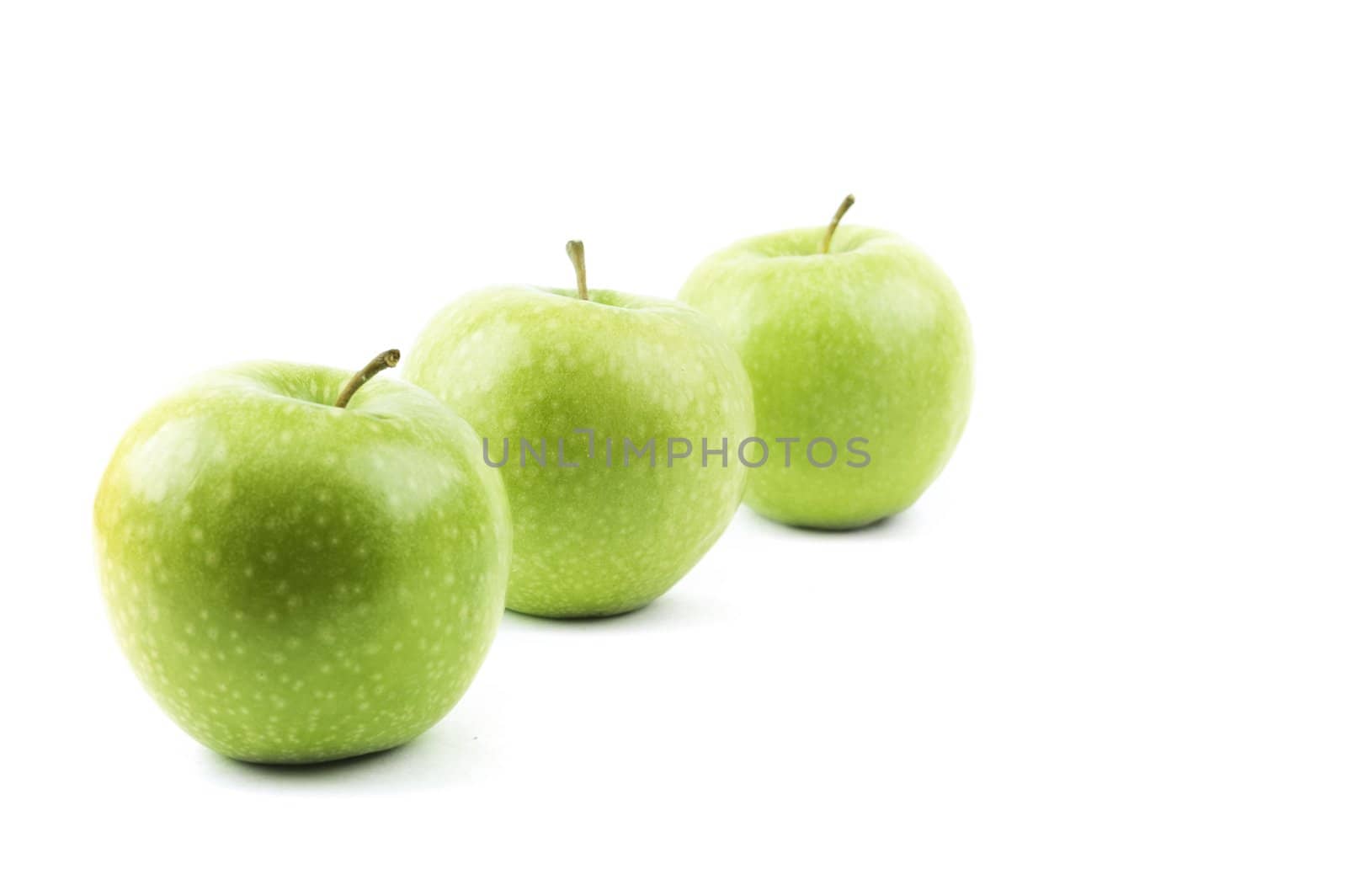 isolated perspective of three green apples