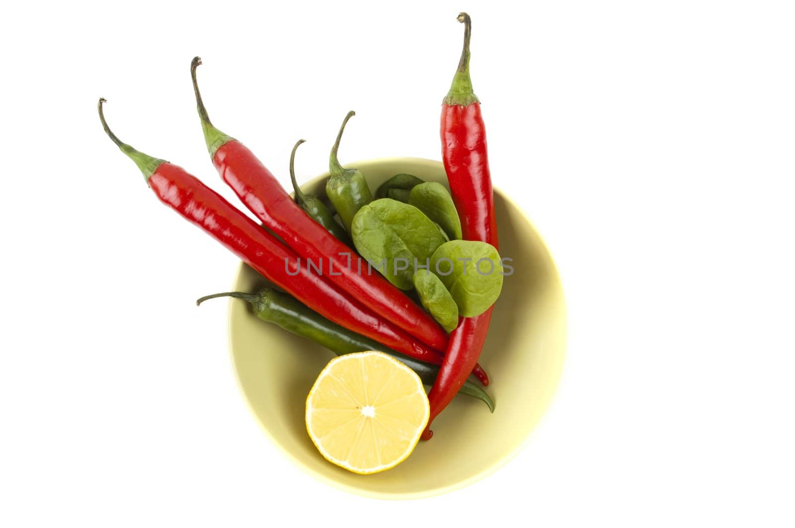 isolated pack of chili peppers, lemon on the plate by Triphka