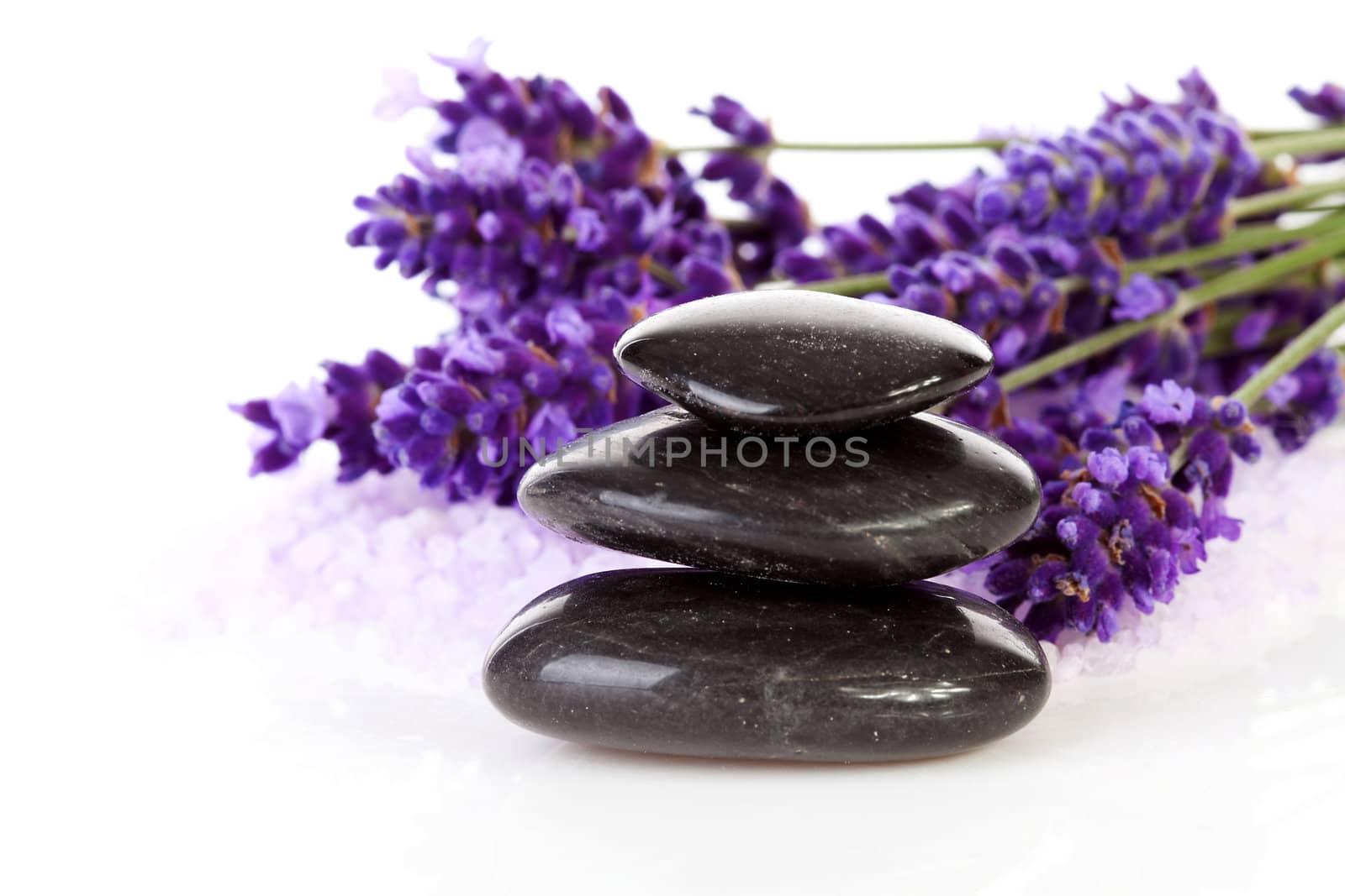 stacked black steping stones and lavender flowers over white background