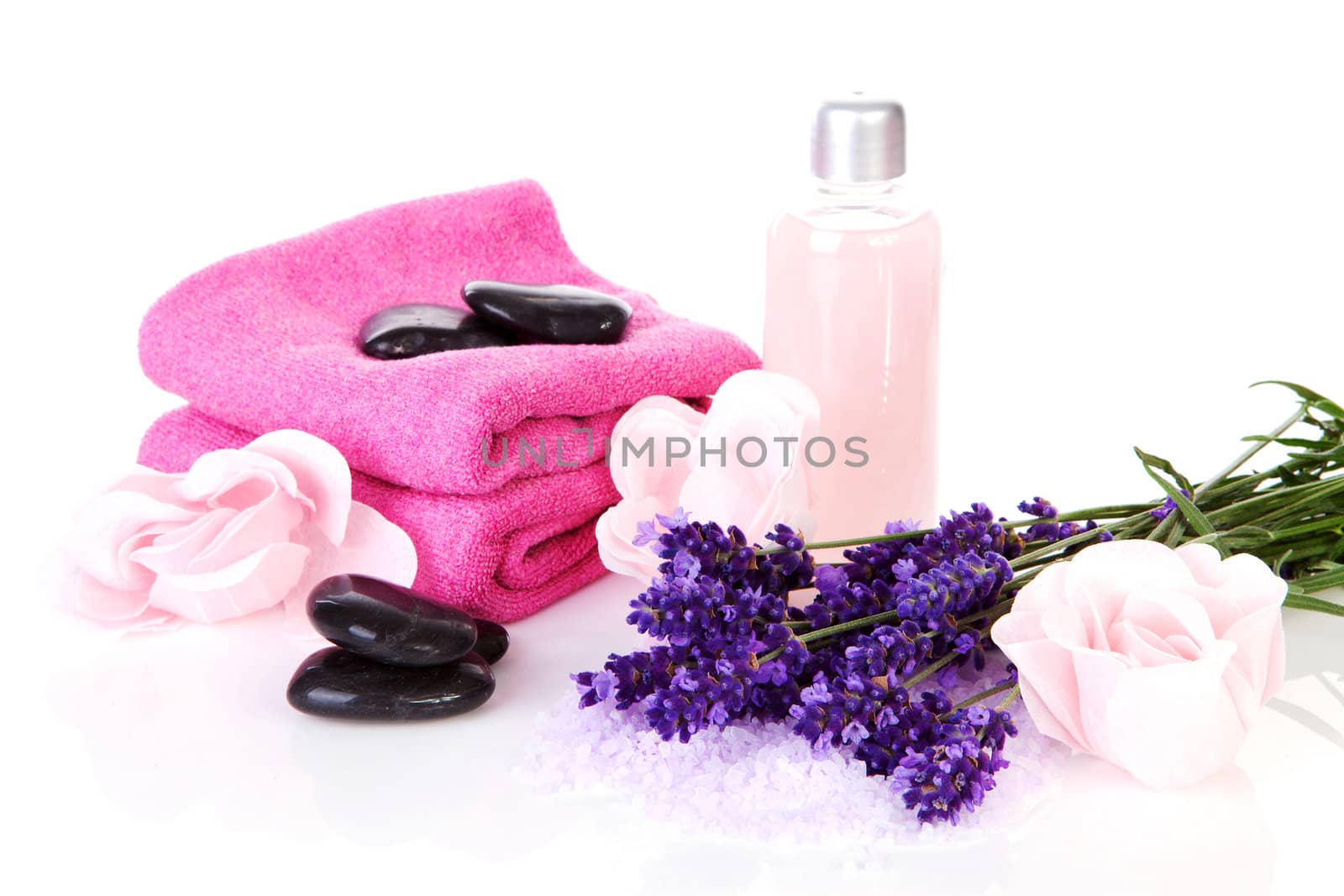Spa accessory with pink towels, black stapping stones and lavender flowers