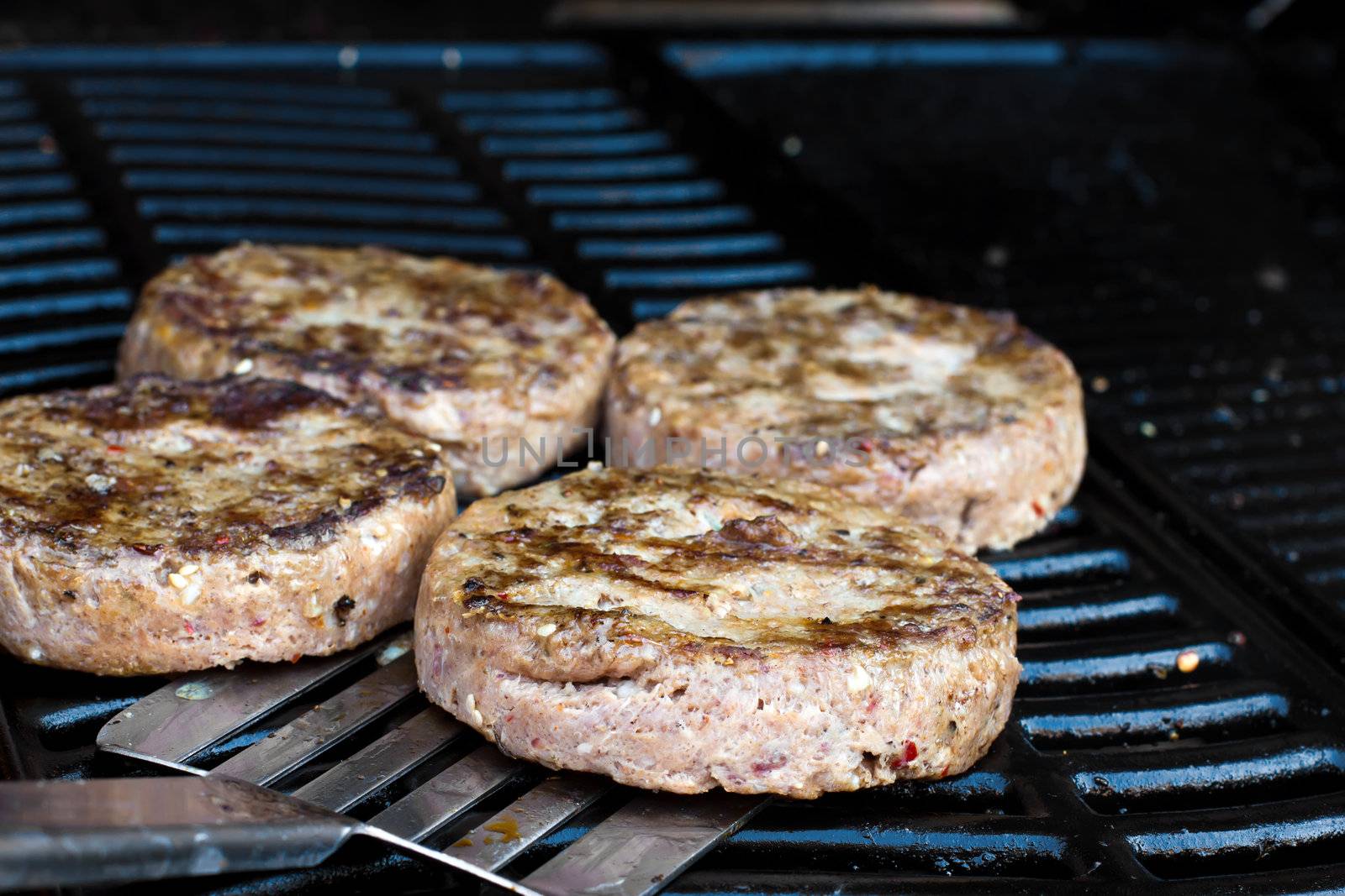 Beef quarterpounder burgers cooking on the gas barbecue