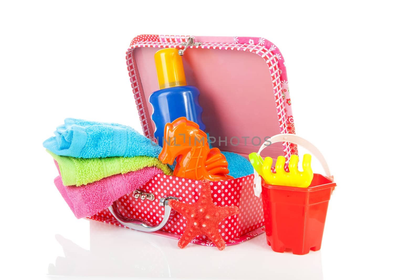 Going to the beach; accessories and suitcase over white background