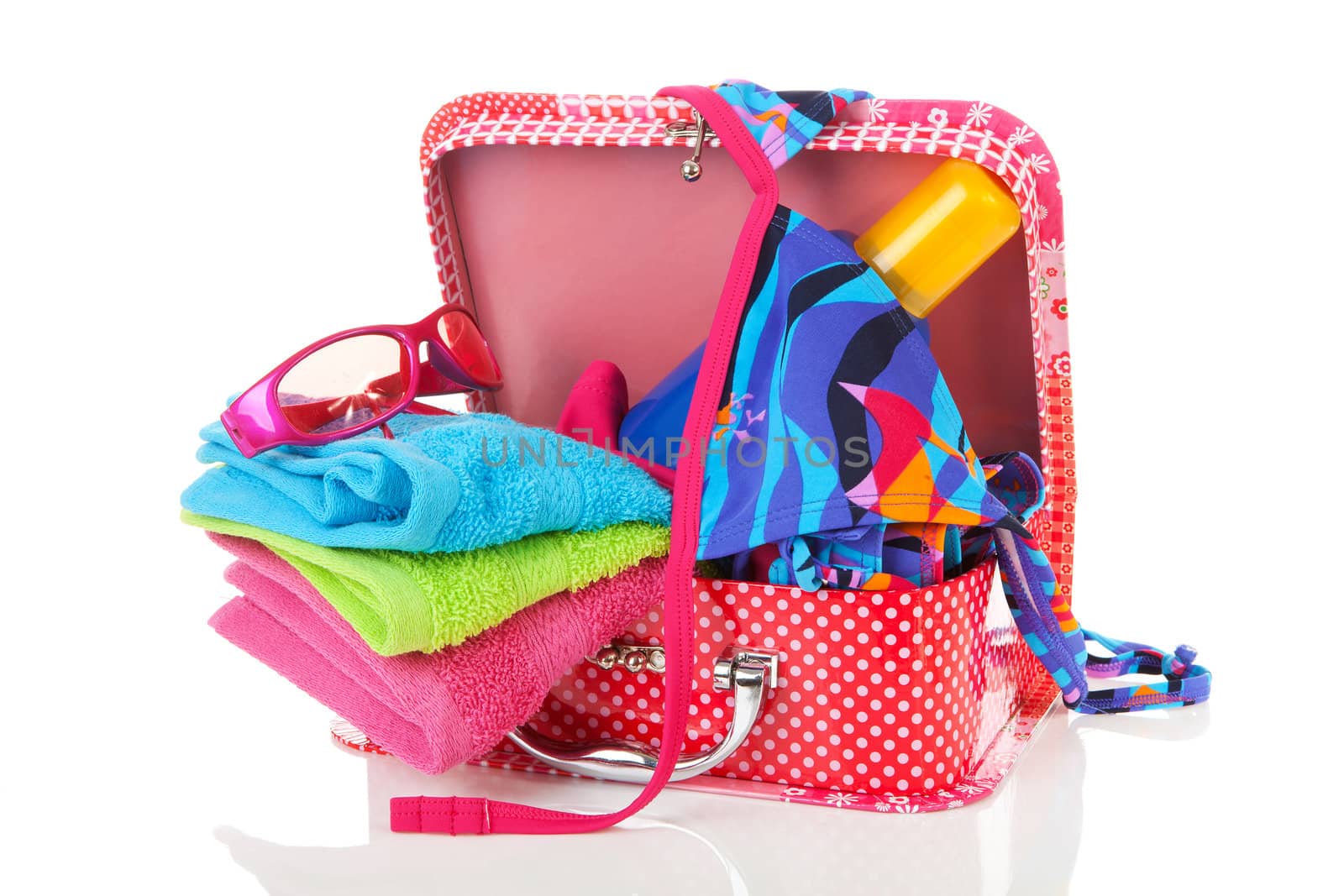 Going on vacation; accessories and suitcase over white background