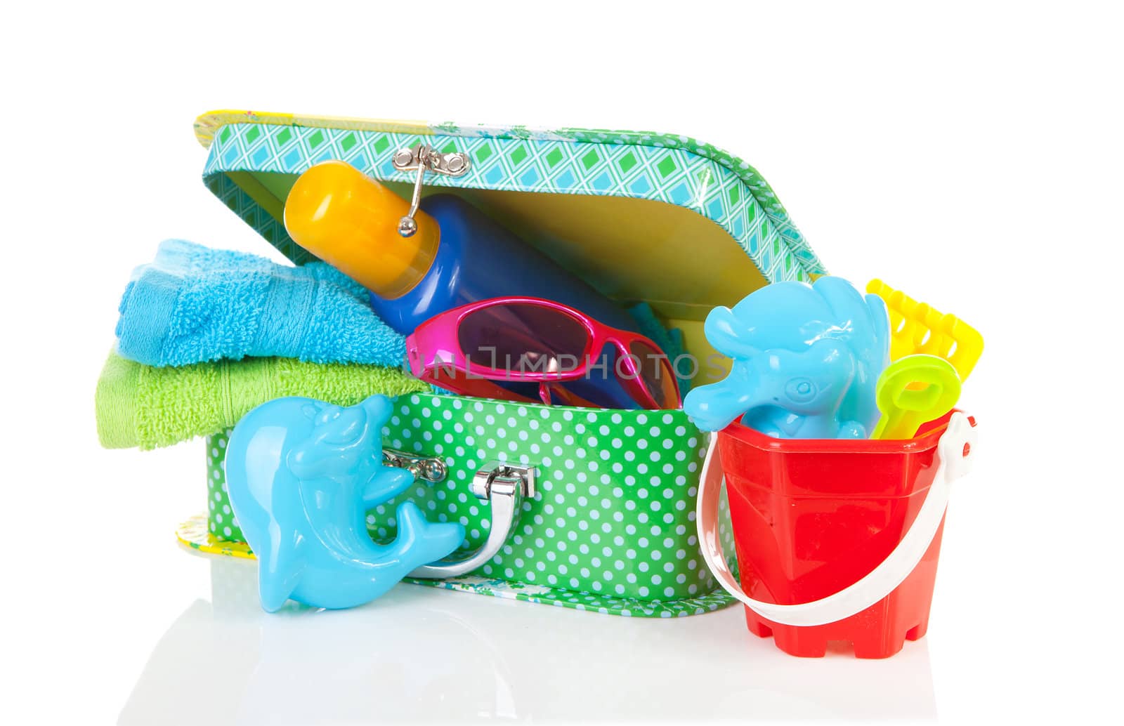Going to the beach; accessories and suitcase over white background