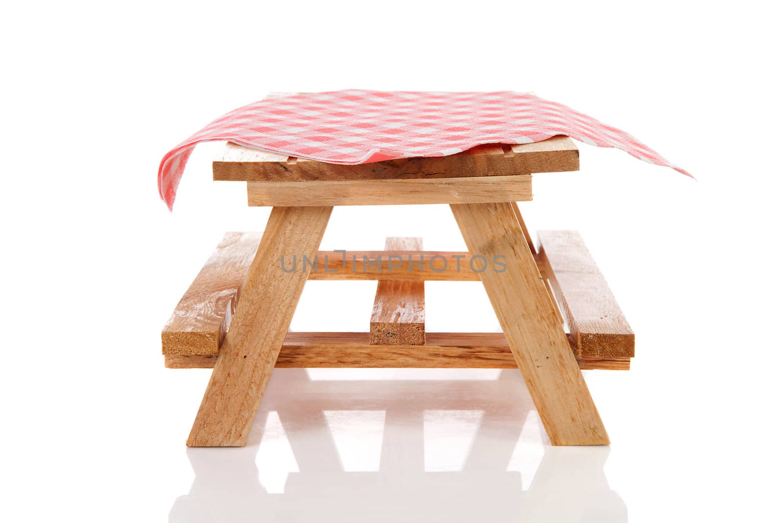 empty picnic table with tablecloth over white background