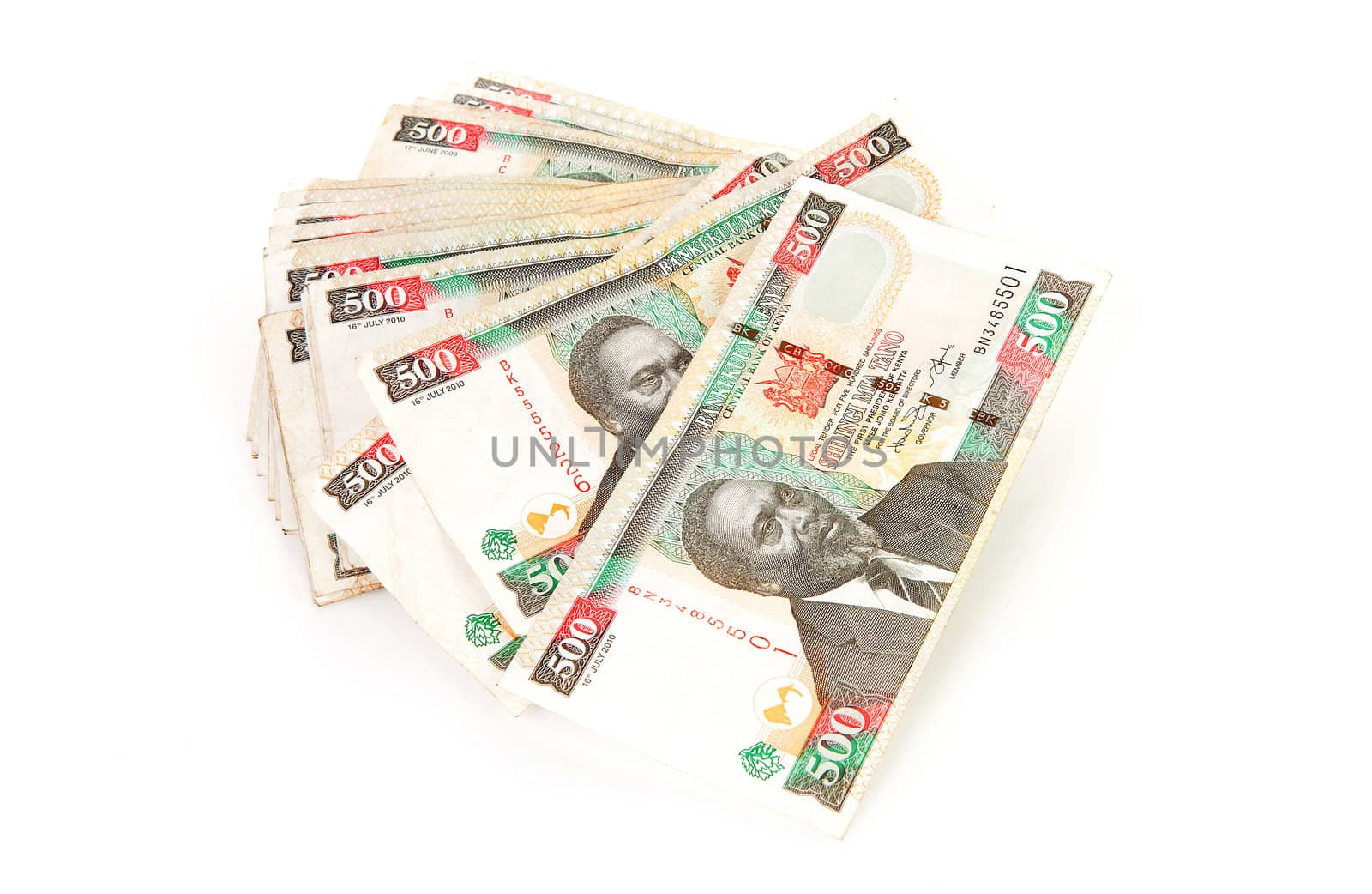 Pile of Kenyan currency over white background