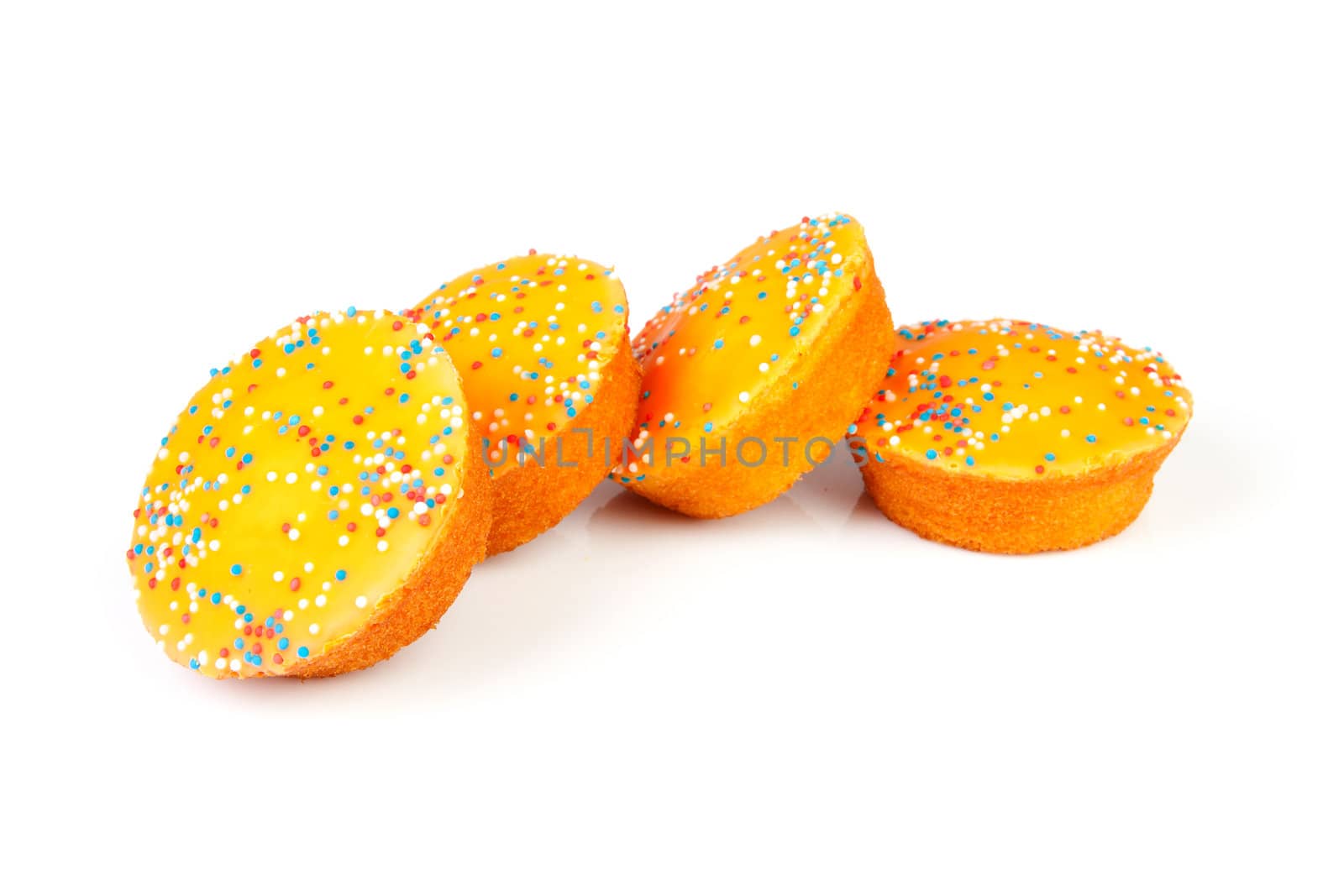 Four orange cake cookies for Dutch soccer with confetti over white background