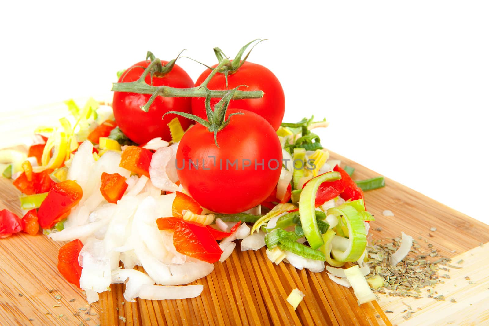 Ingredients for spaghetti on wooden cutting board over white background
