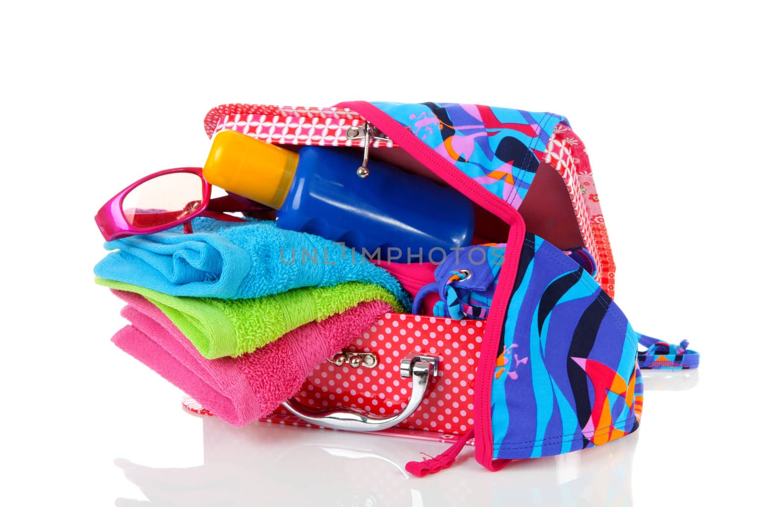 Going on vacation; accessories and suitcase over white background