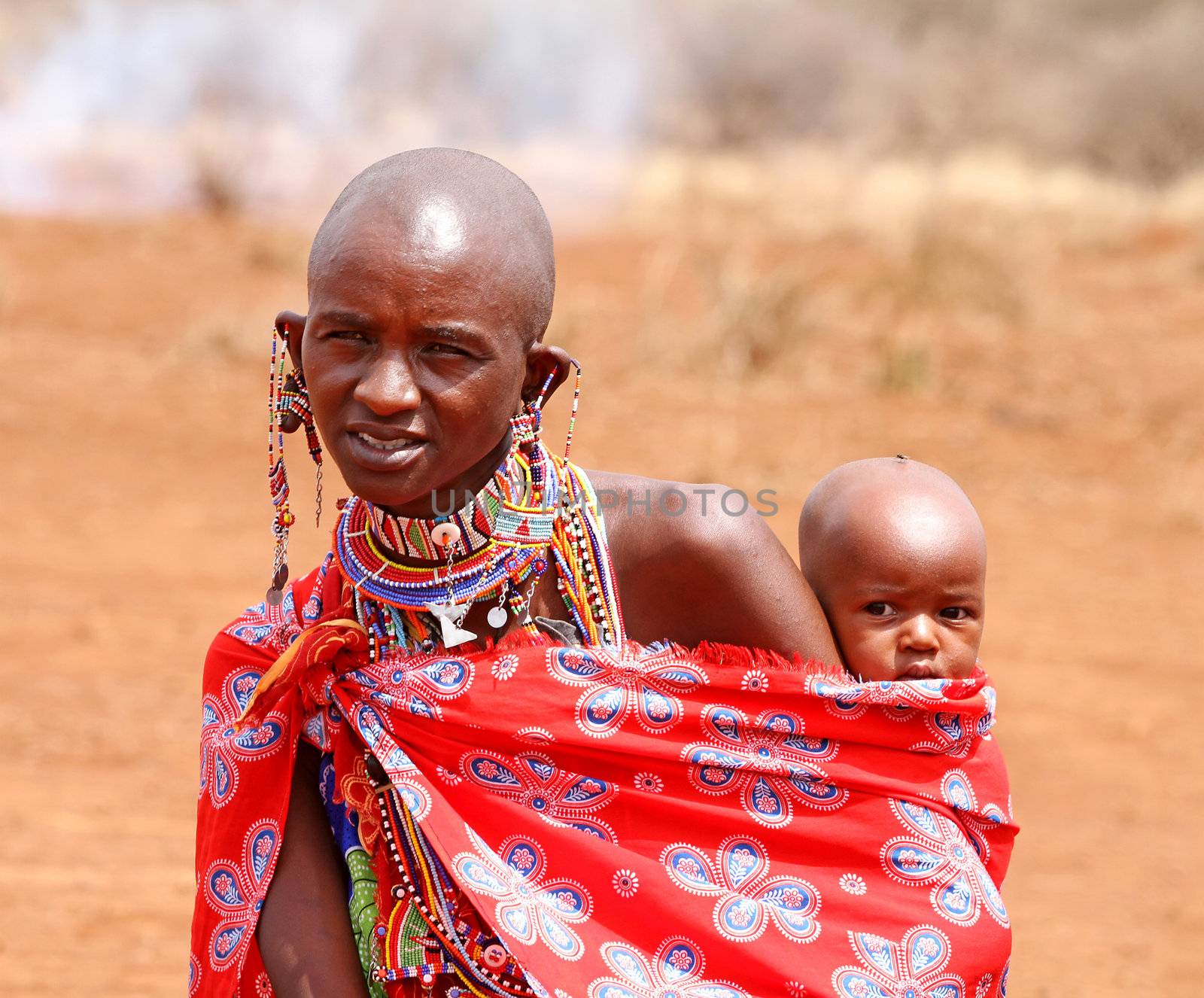 MASAI MARA, KENYA - JULY-2: unidentified African women from Masai tribe with baby by traditional welcome dance on July 2, 2011 in a local village near Masai Mara National park, Kenya . 