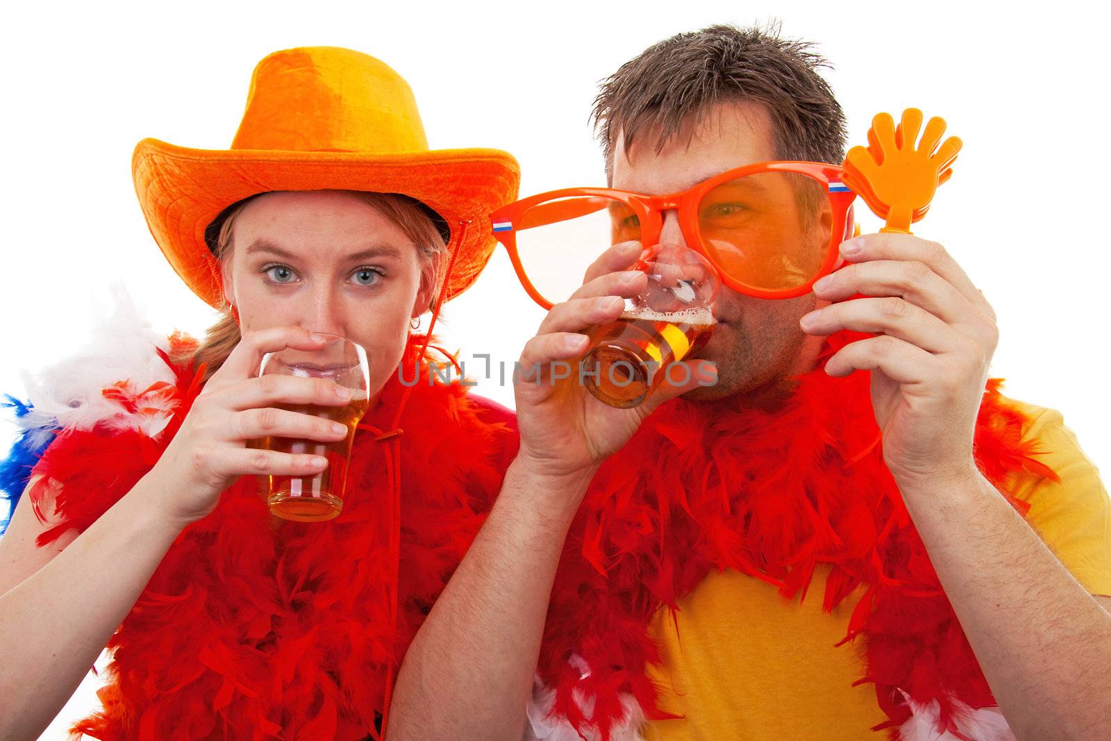 Two Dutch soccer fans in orange outfit with glasses of beer, over white background