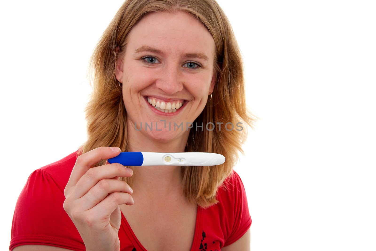 Woman with pregnancy tast is smiling because she is pregnant, over white background