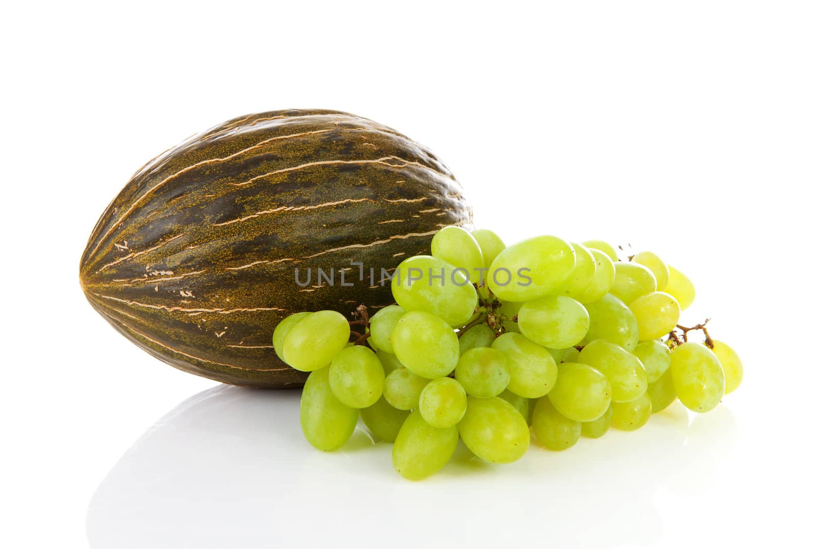 Fresh melon and grapes over white background