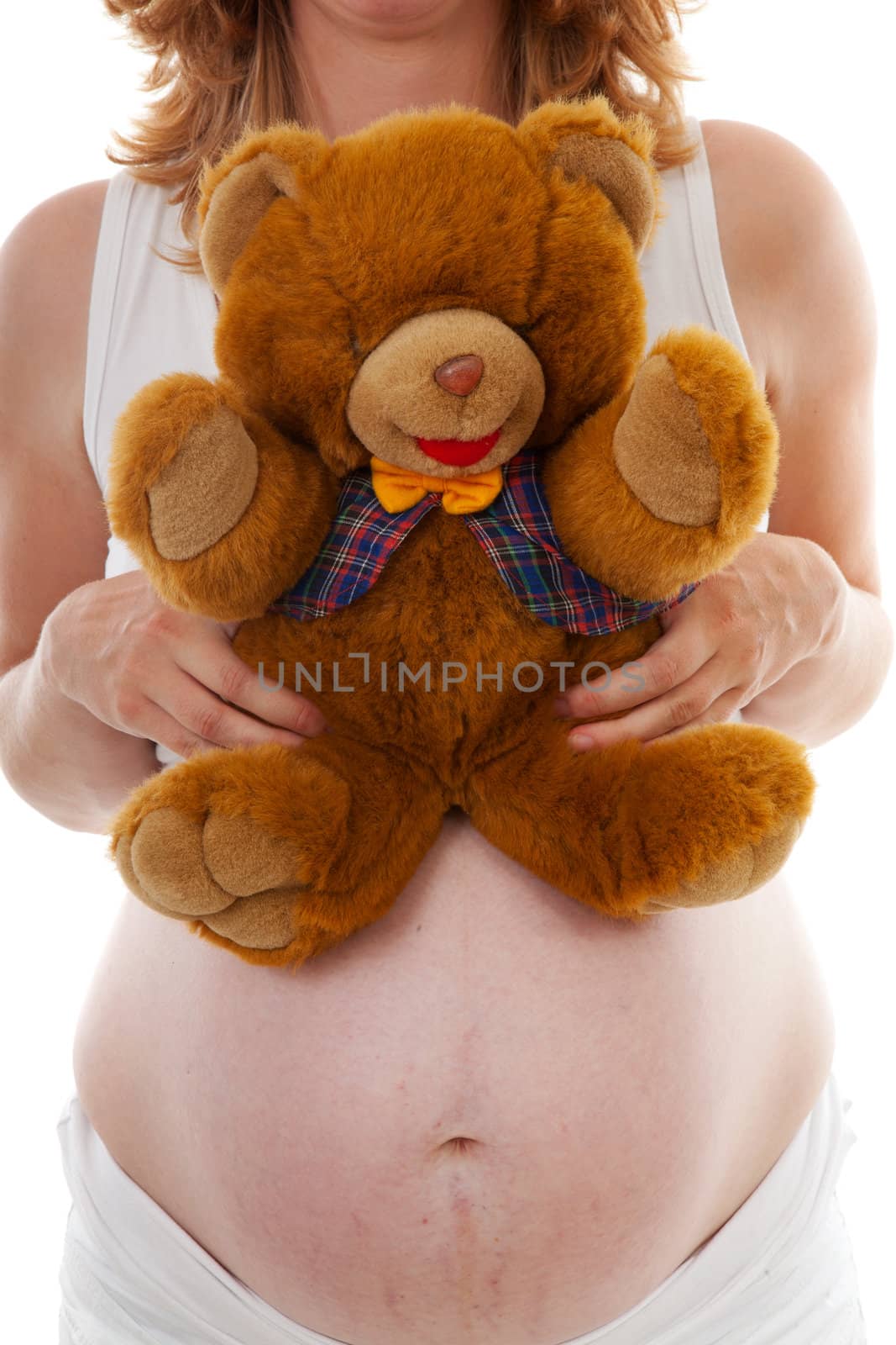 pregnant belly with Teddy bear over white background