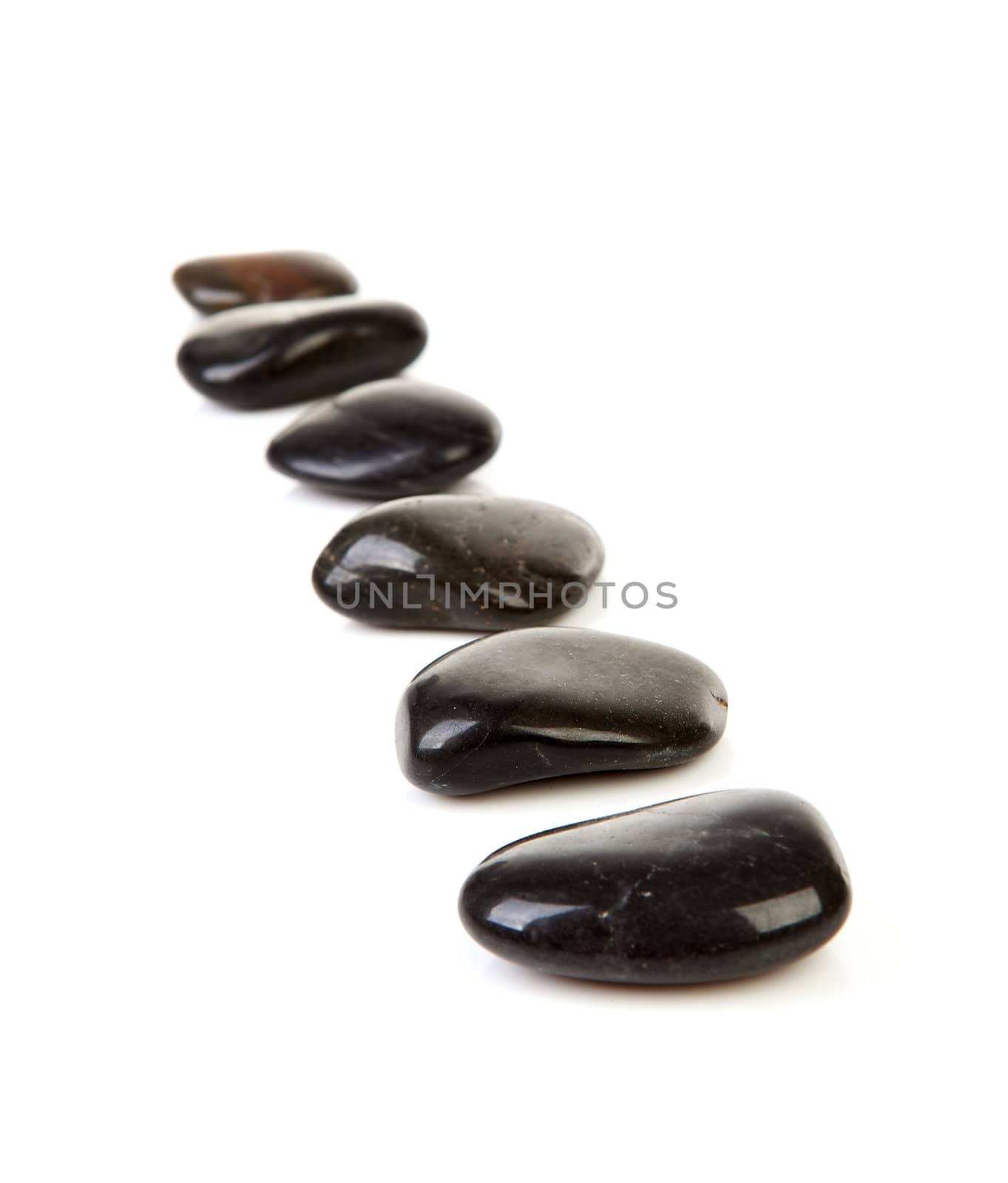 Black stepping stones in a row over white background 

