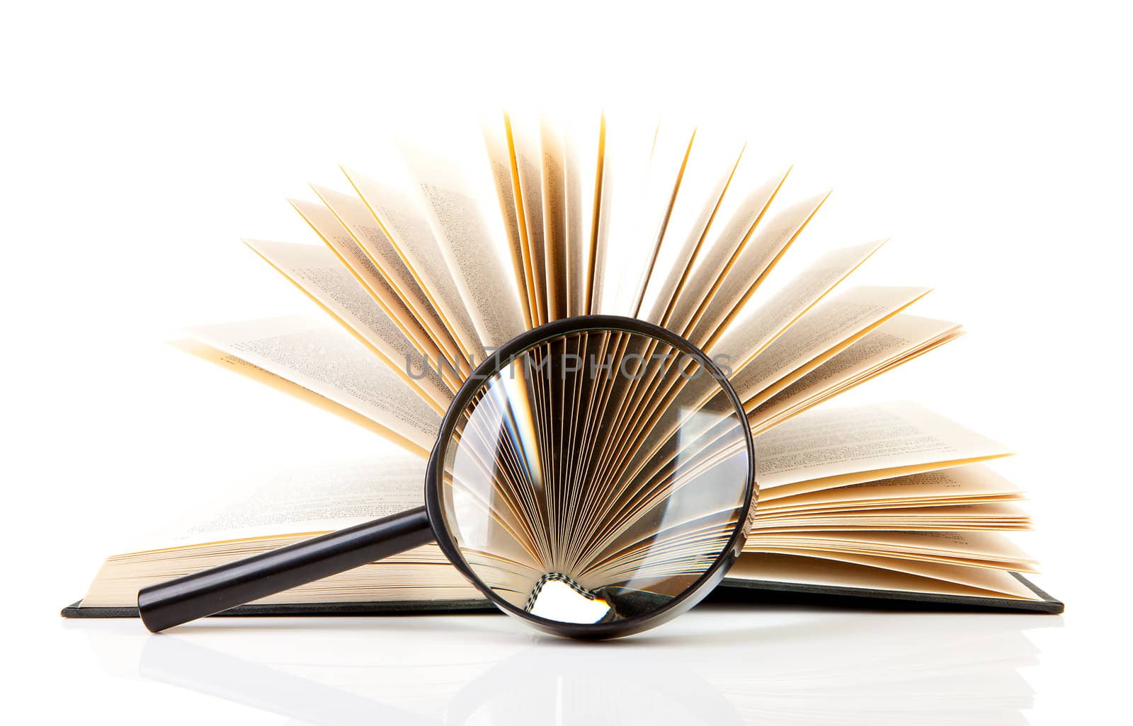 open book with magnifying glass over white background