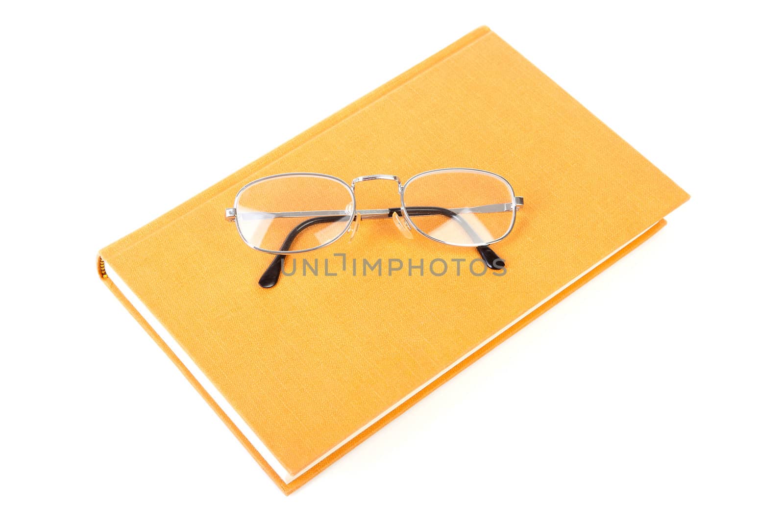 book with reading glasses isolated on white background