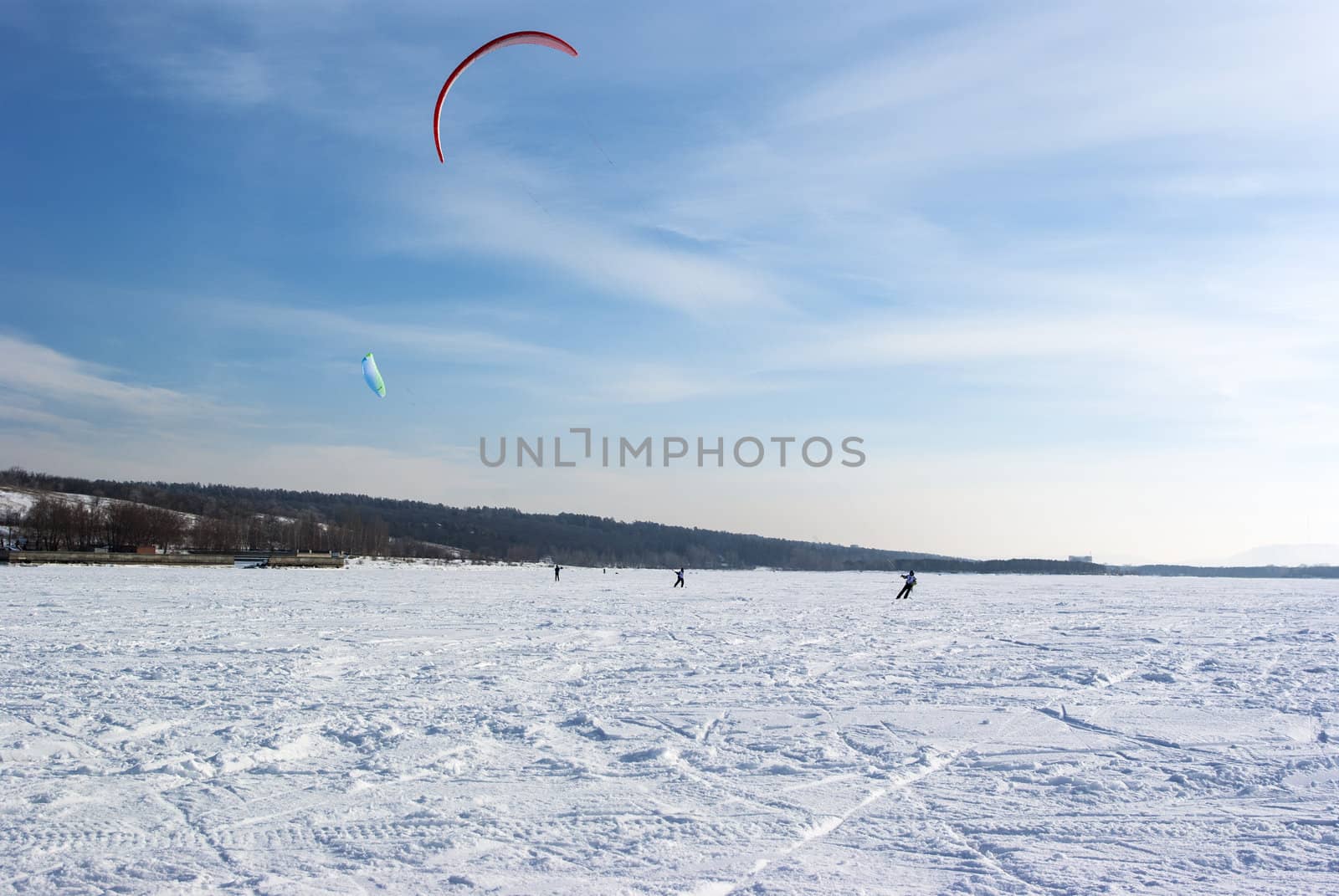 Winter kite skiing on the frozen river