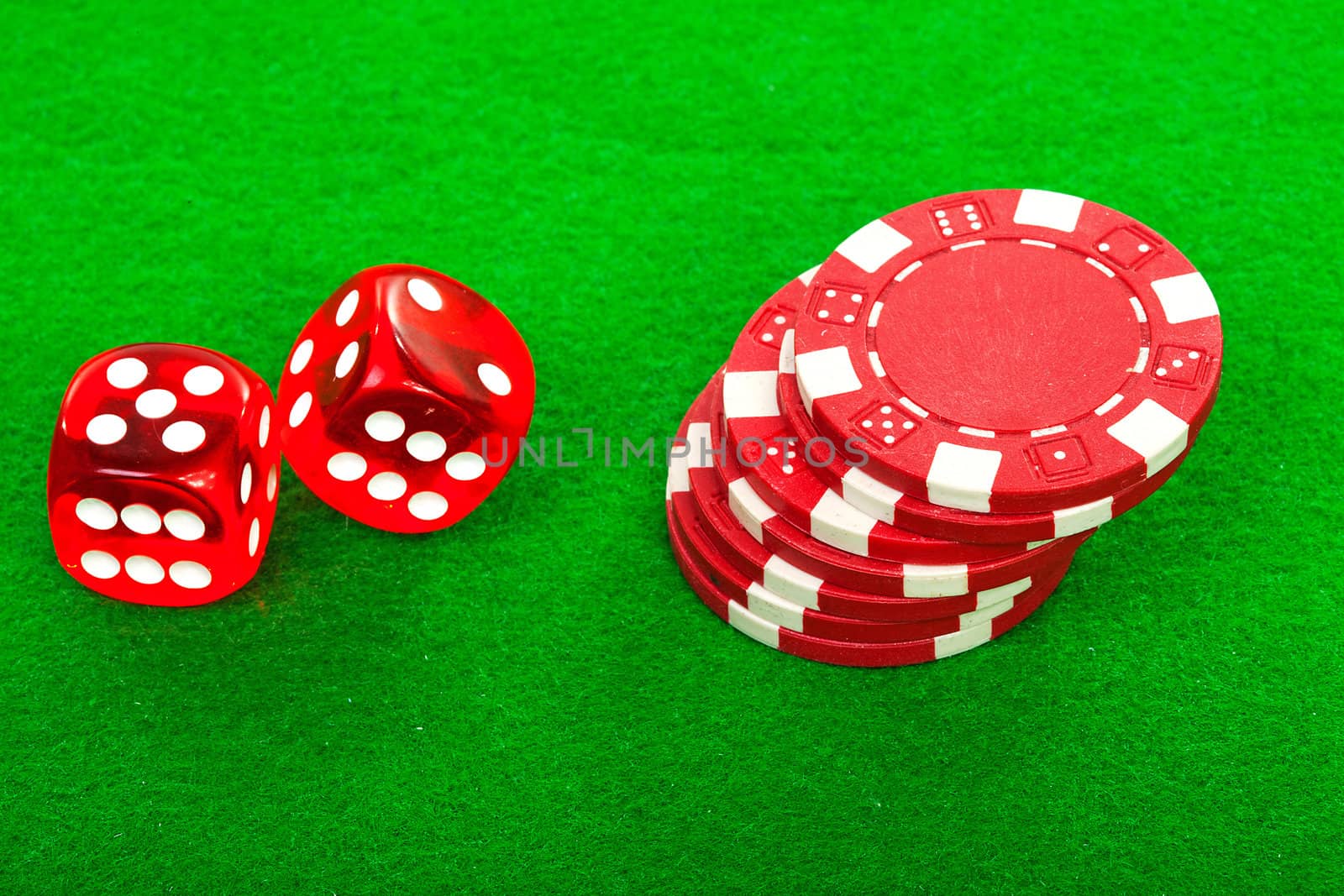 casino chips and red dices over green background