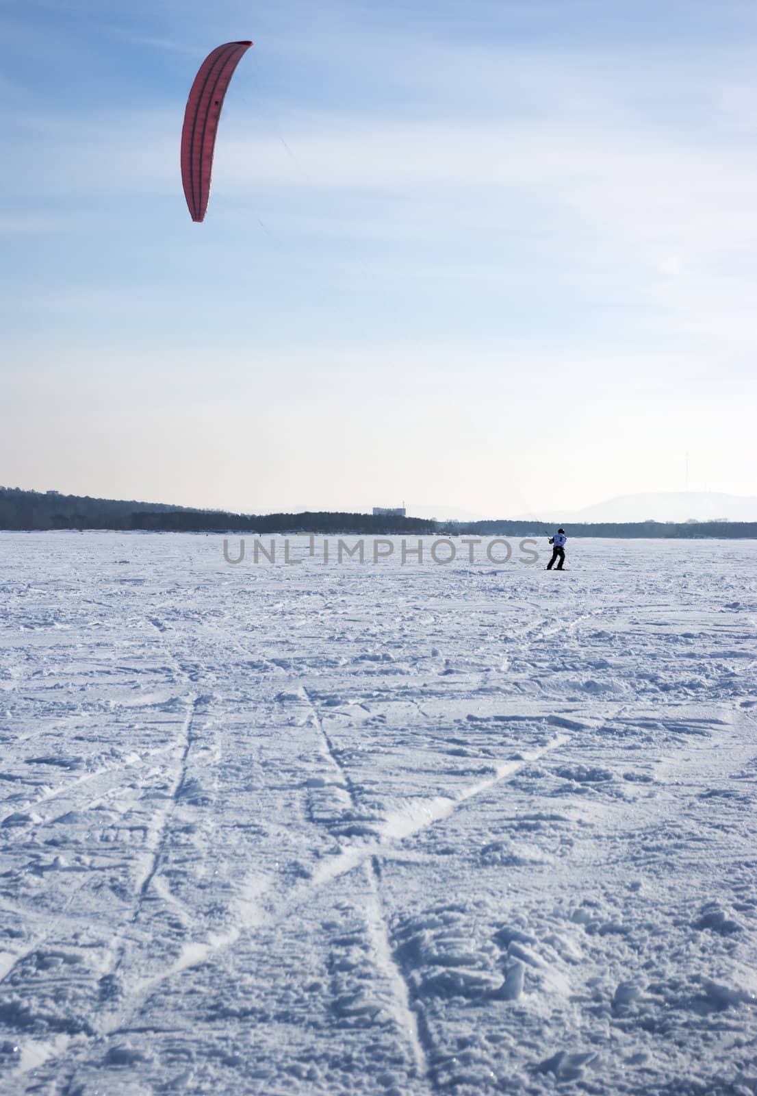 Winter kite skiing on the frozen river