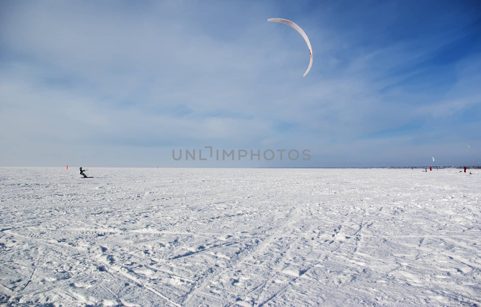 Winter kite skiing on the frozen river