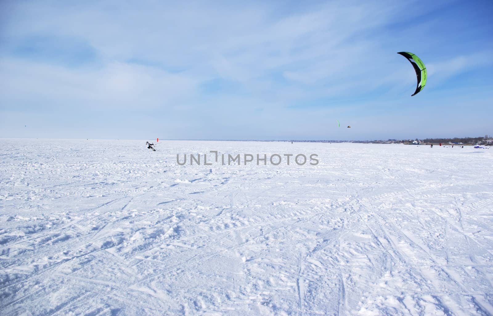 Winter kite skiing on the frozen river