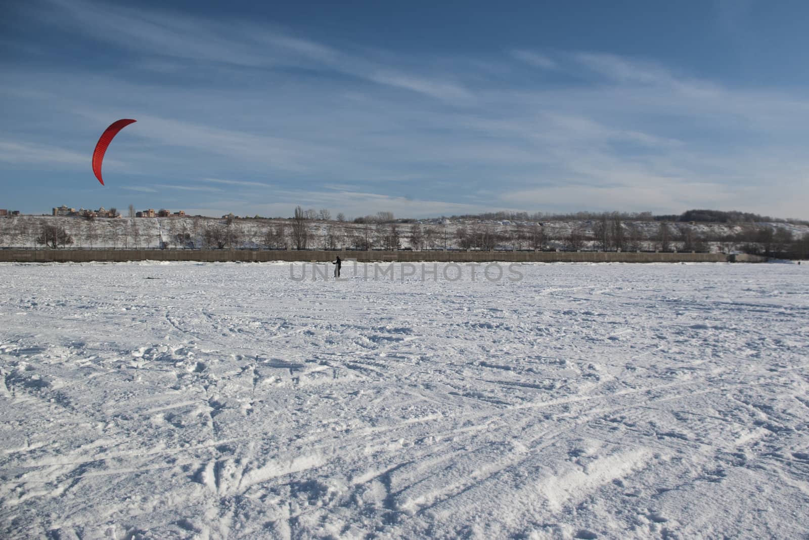 Winter kite skiing on the frozen river