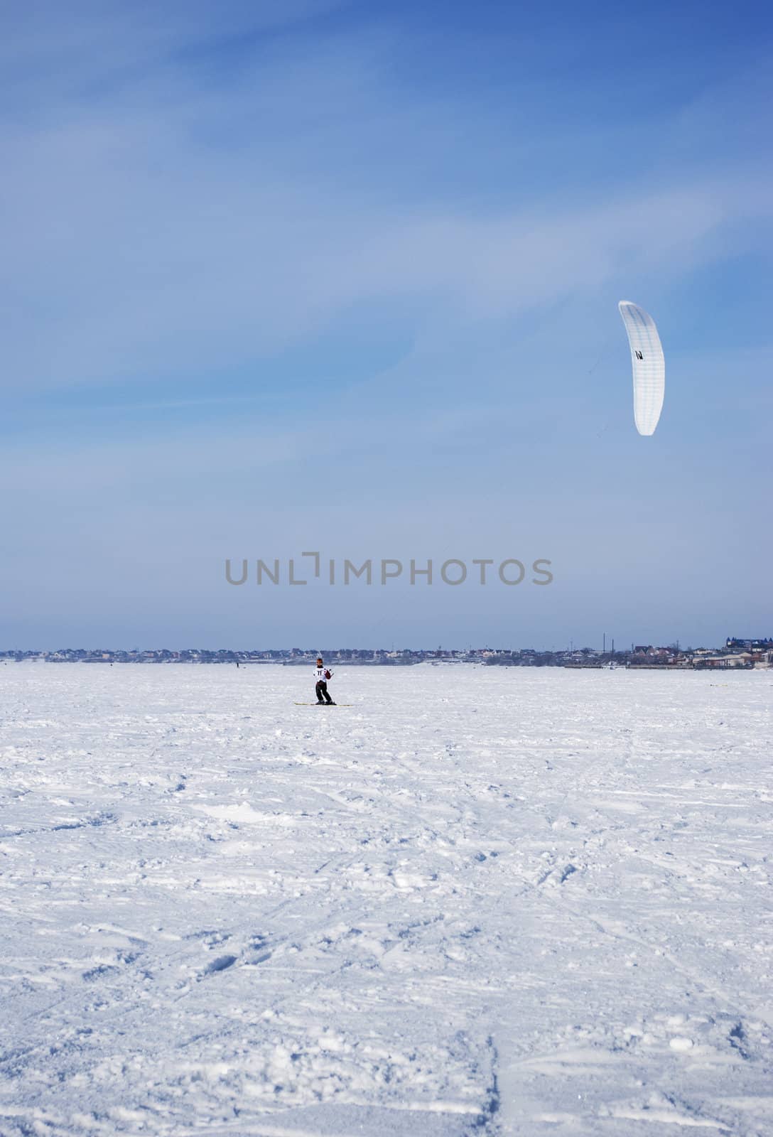 Winter kite skiing on the frozen river