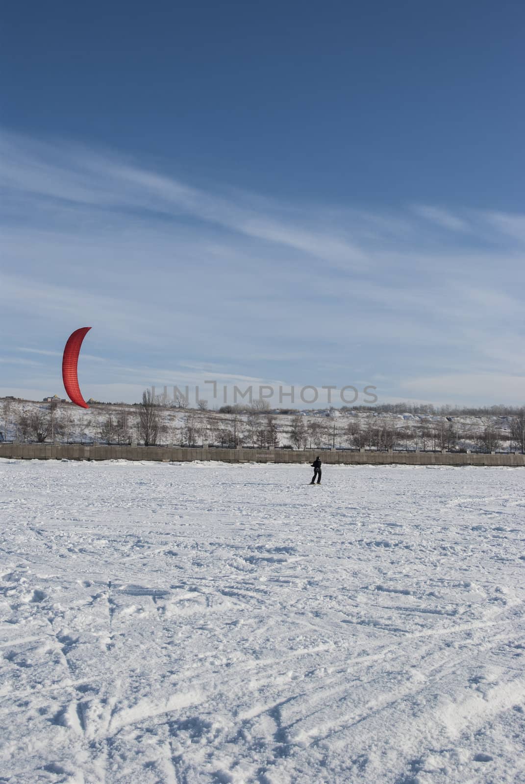 Winter kite skiing on the frozen river