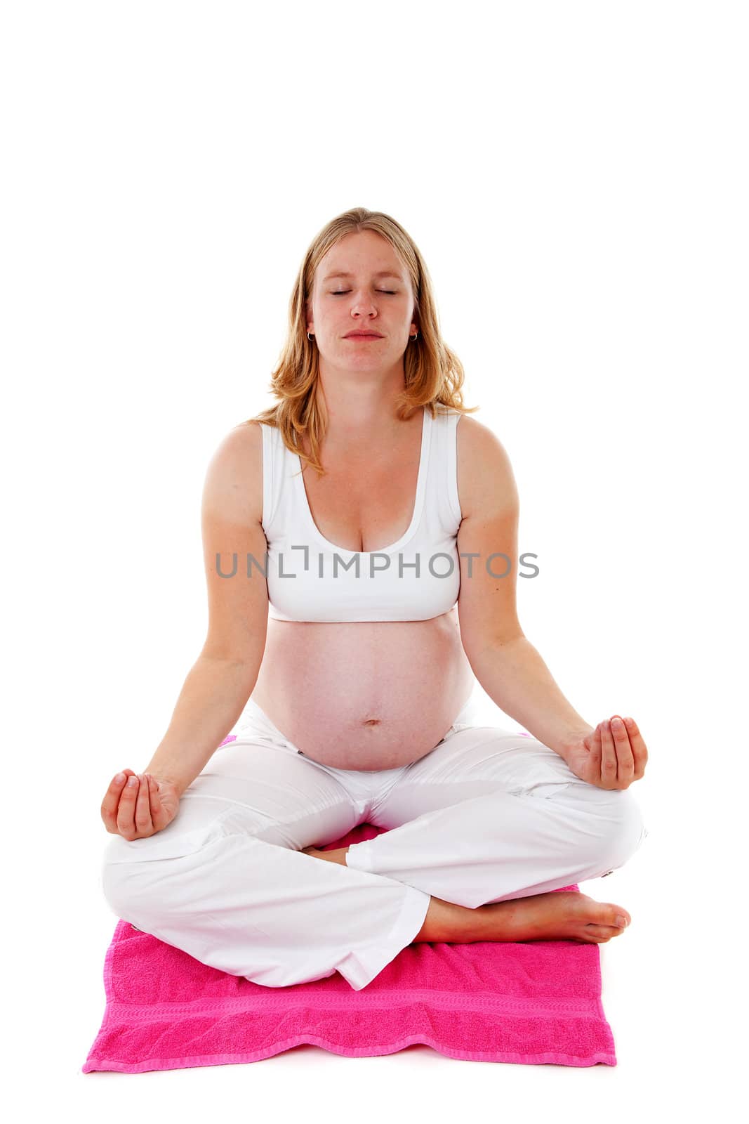 woman doing meditative pregnancy yoga over white background
