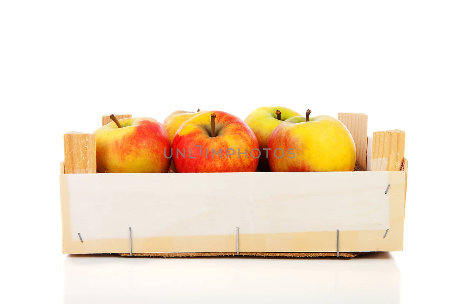 wooden box of apples over white background