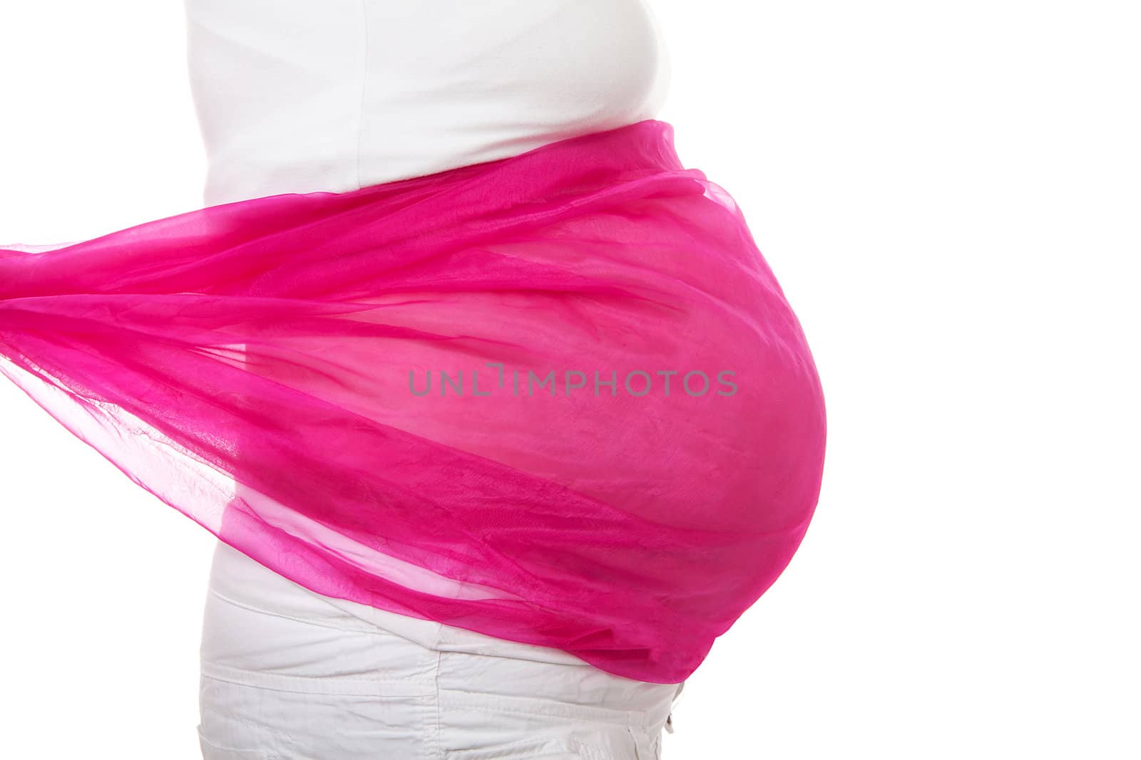 closeup of pregnant belly with pink cloth over white background