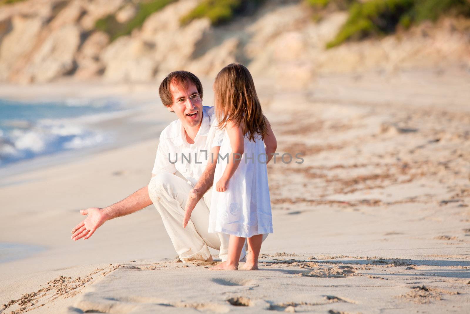 happy family father and daughter on beach having fun summer vacation