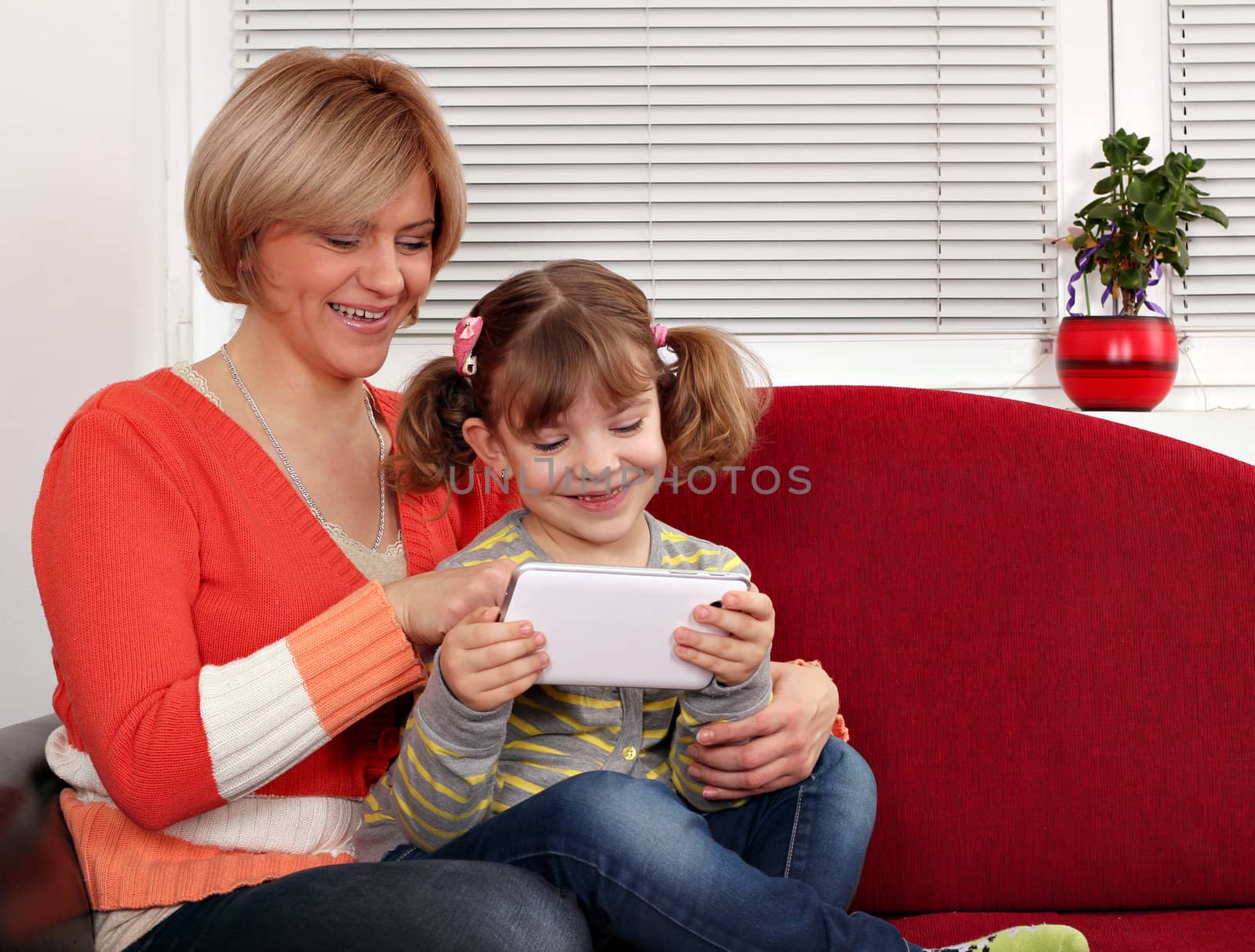 happy mother and daughter with tablet pc family scene by goce
