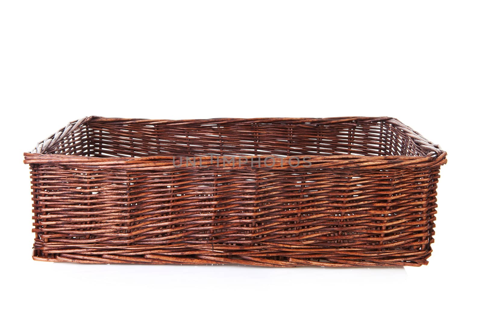 Big empty cane basket over white background