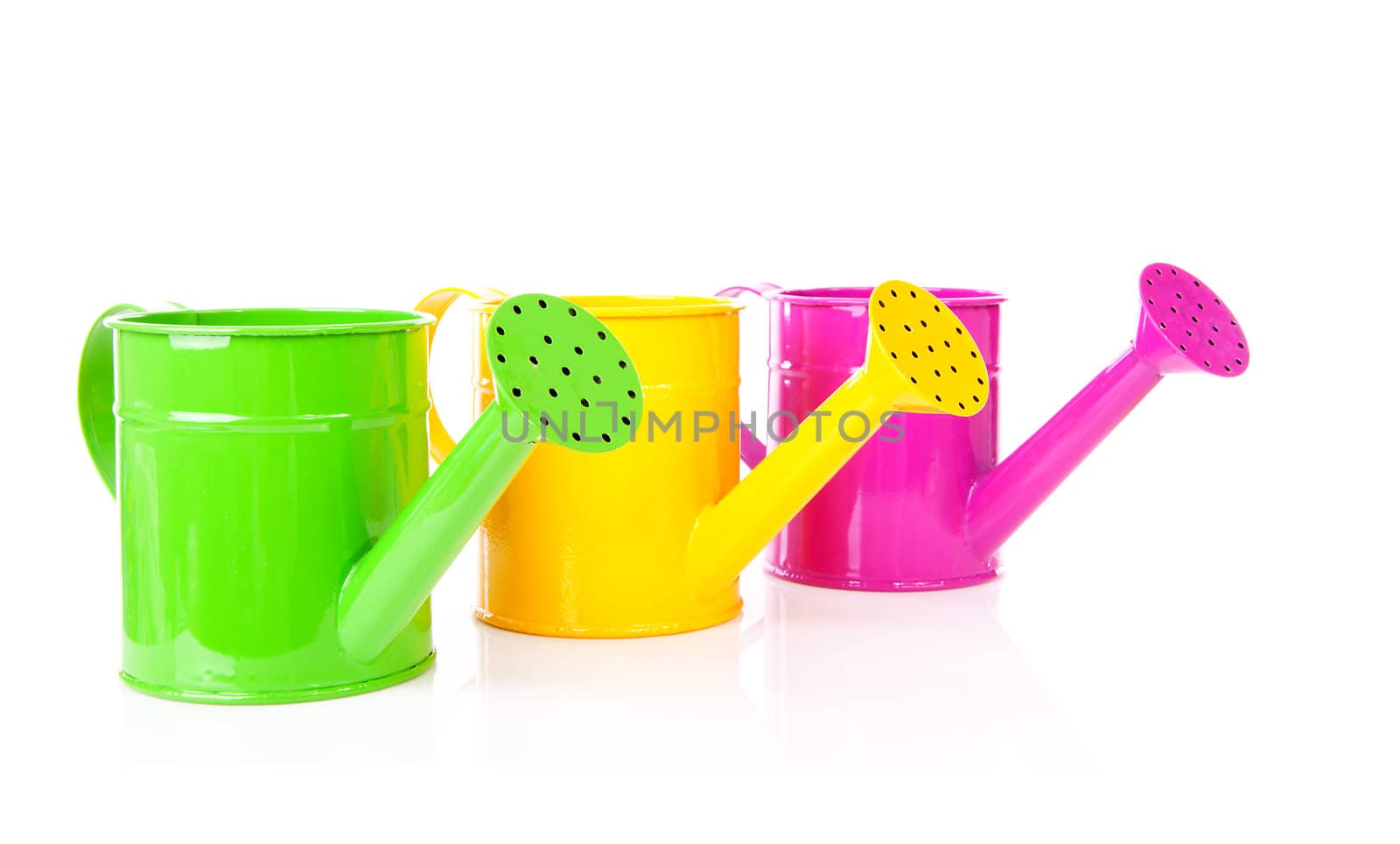 Three colorful watering cans over white background