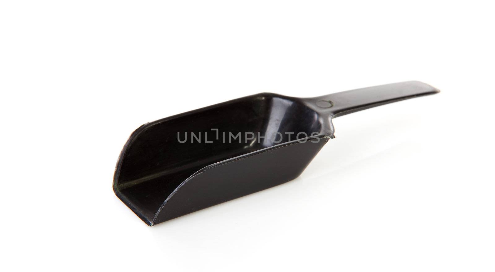 Black plastic measuring spoon over white background