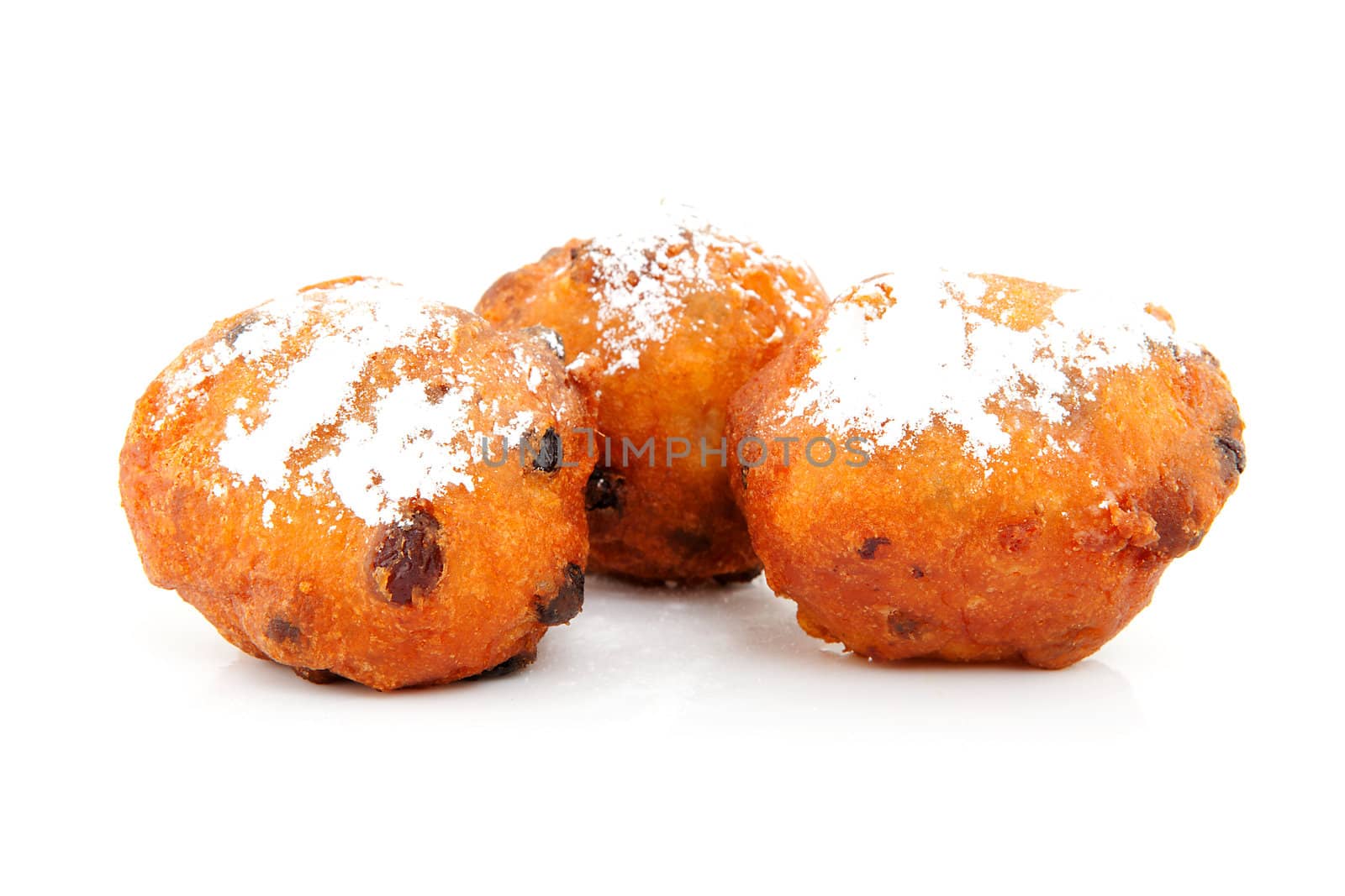 Three Dutch donut also known as oliebollen, traditional New Year's eve food isolated on white background