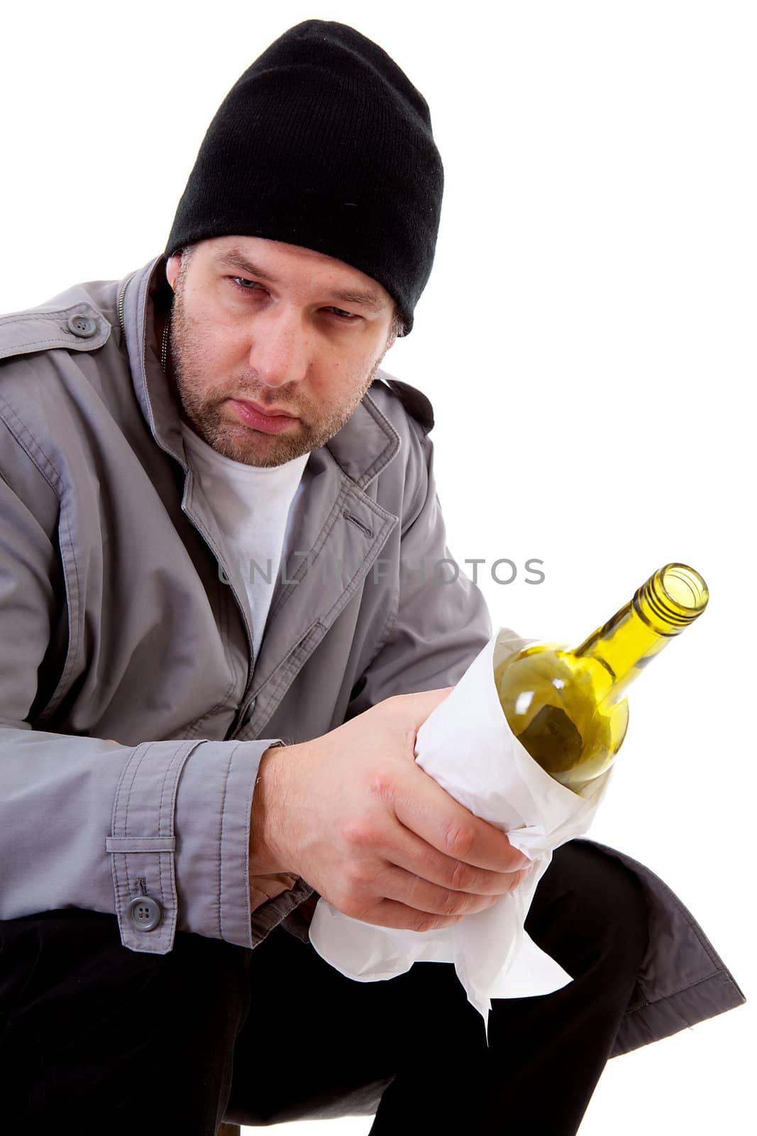 male homeless tramp with empty bottle over white background