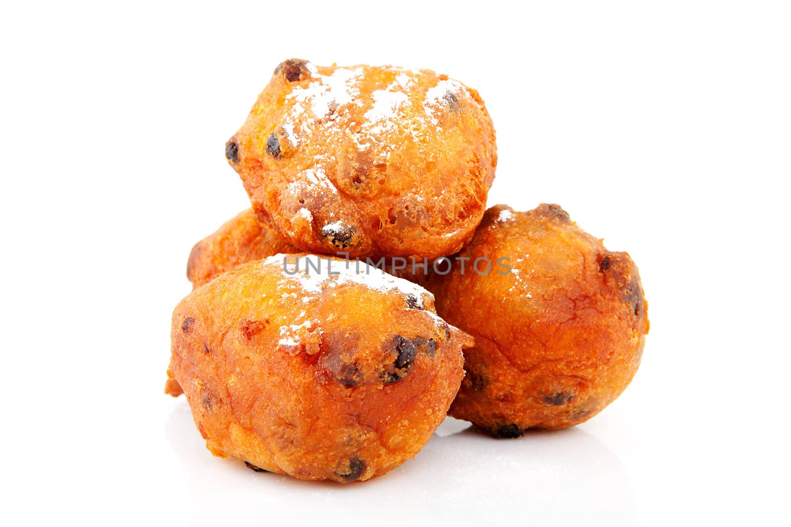 Pile of Dutch donut also known as oliebollen, traditional New Year's eve food isolated on white background 
