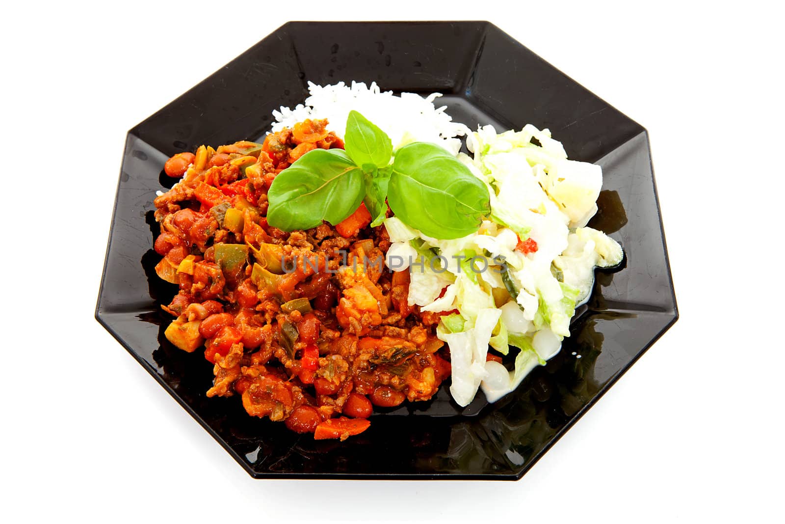plate with delicious chilli con carne, rice and salad over white background