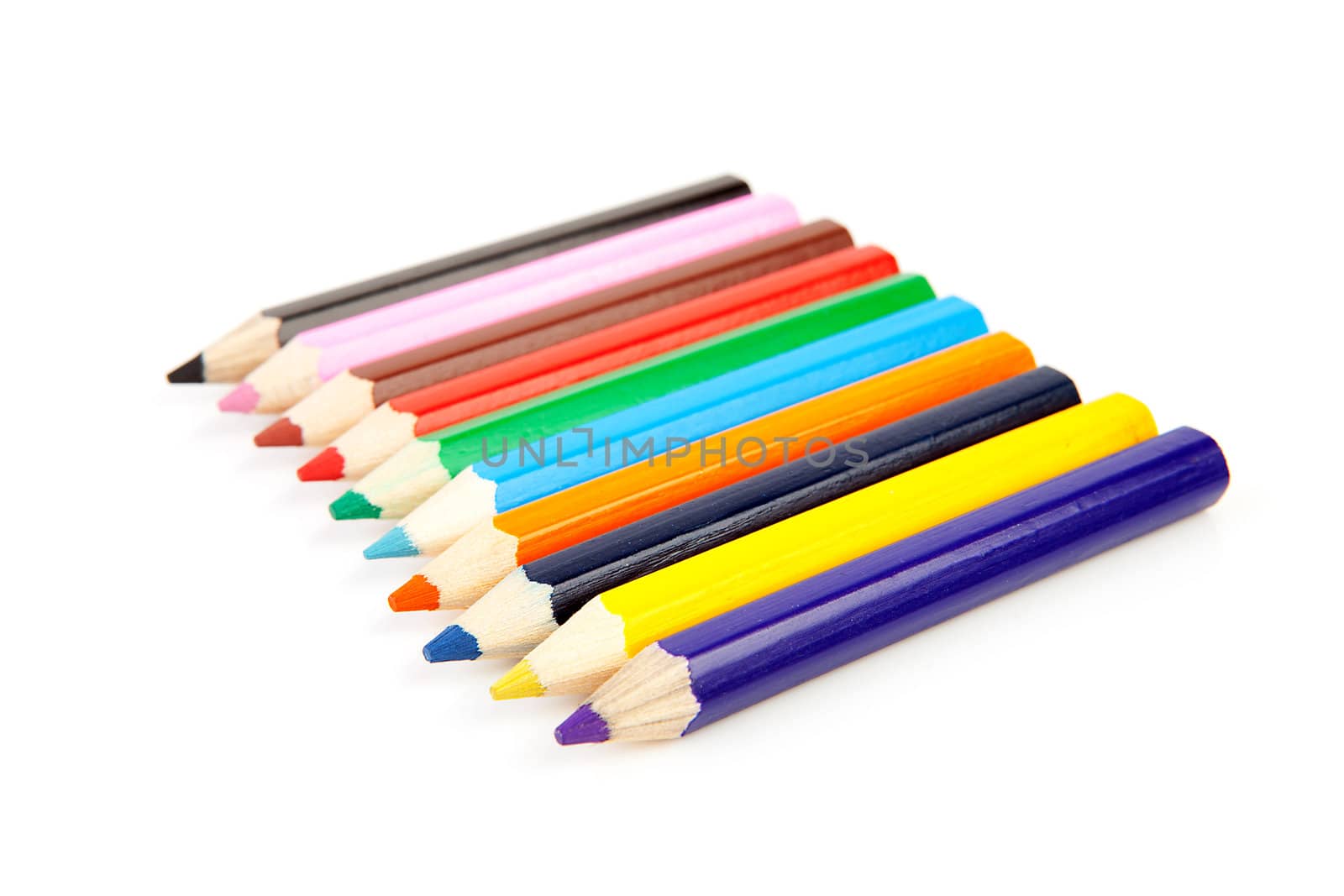 colorful pencils in a row over white background