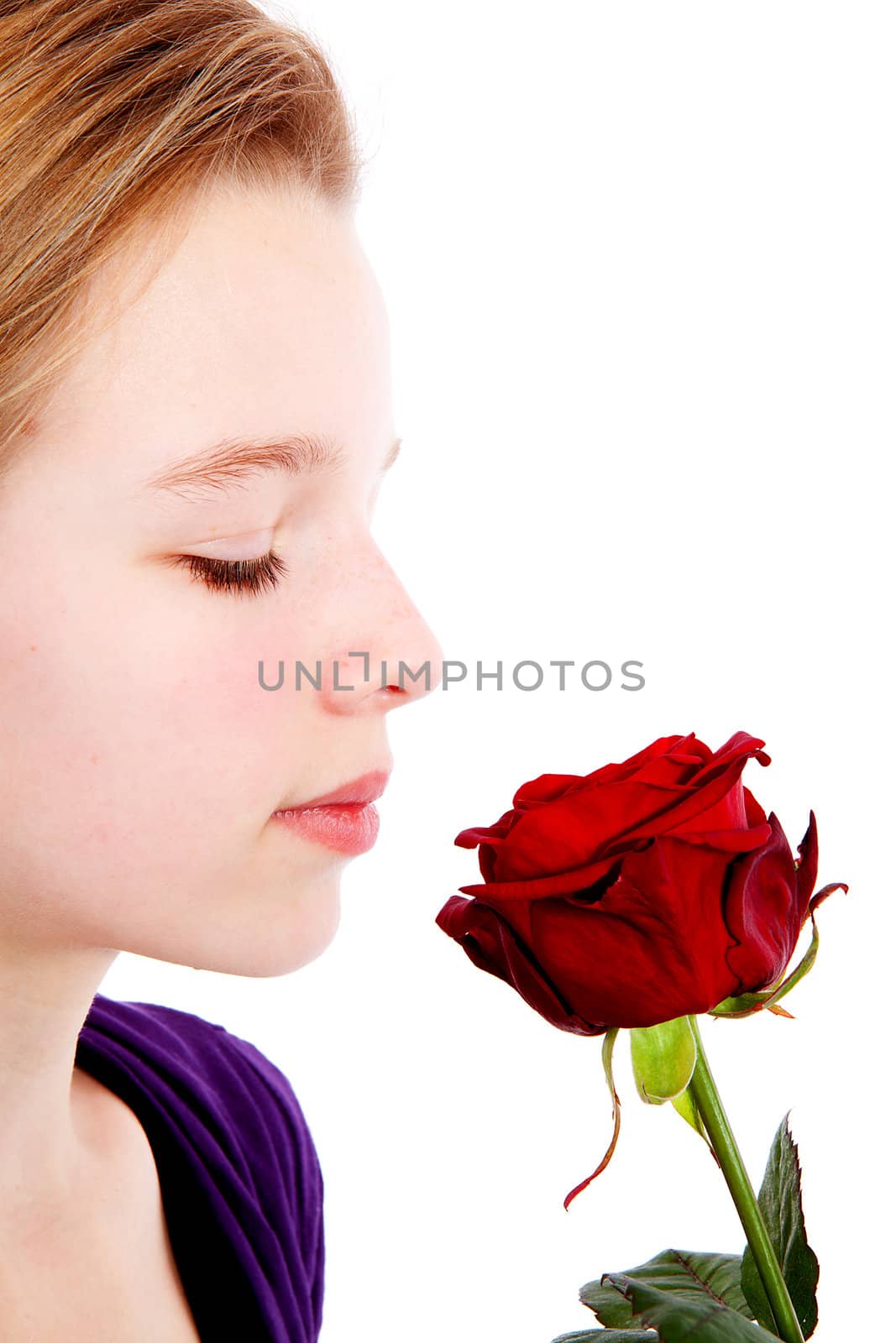 young girl smelling a red rose in closeup by sannie32