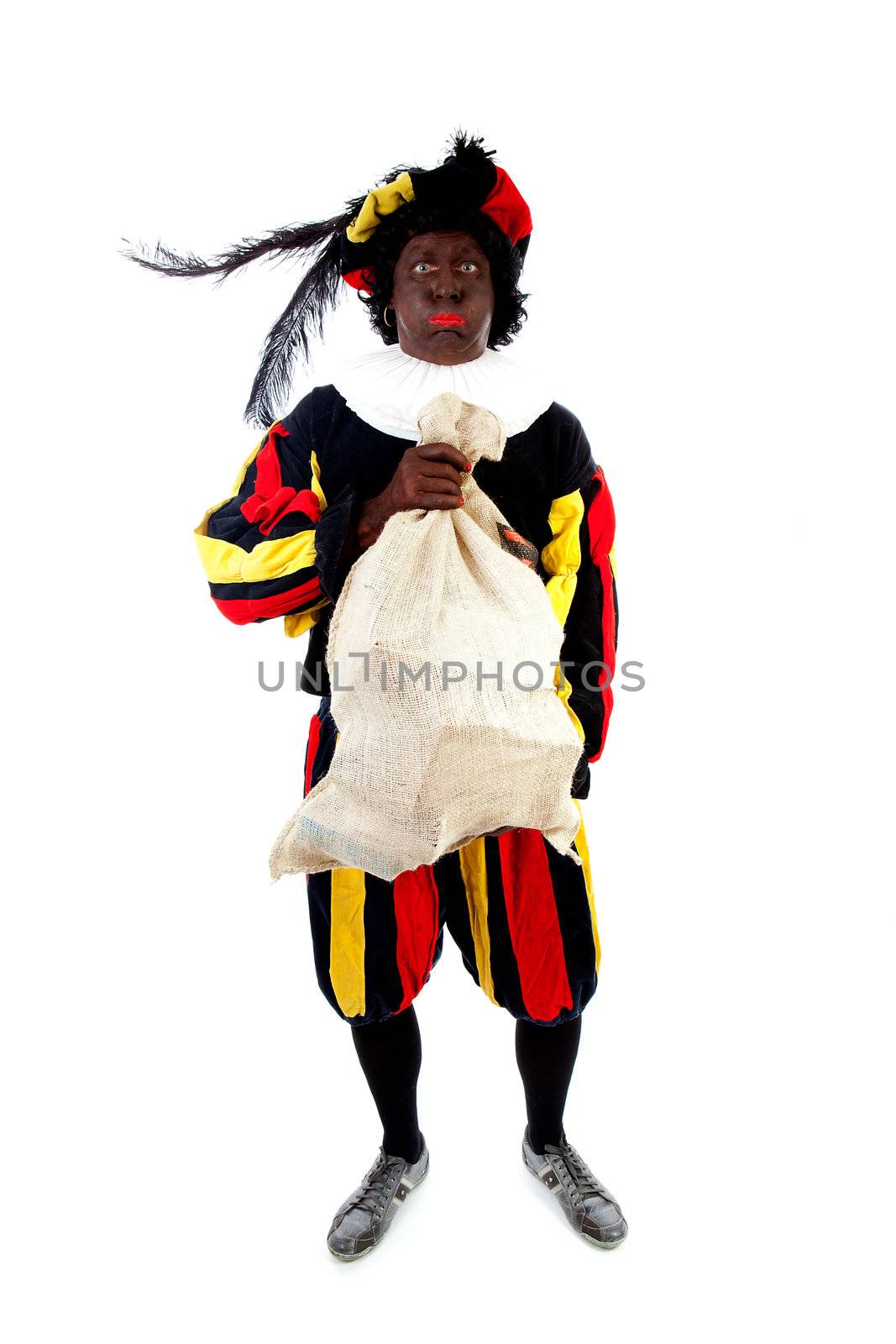 Zwarte piet ( black pete) typical Dutch character part of a traditional event celebrating the birthday of Sinterklaas in december over white background with heavy bag