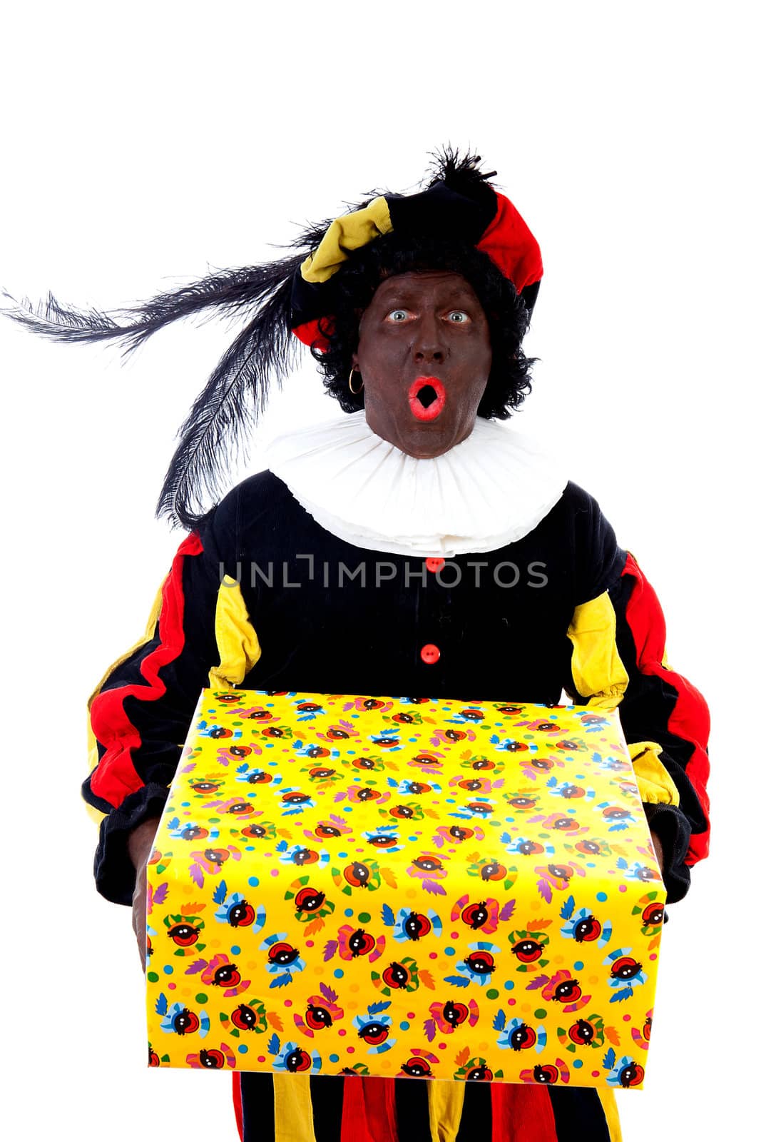 Zwarte piet ( black pete) typical Dutch character part of a traditional event celebrating the birthday of Sinterklaas in december over white background with big present