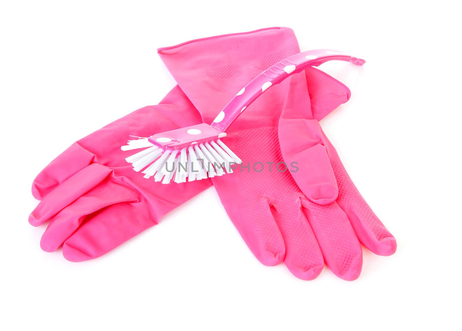 pair of pink household gloves and dish brush over white background