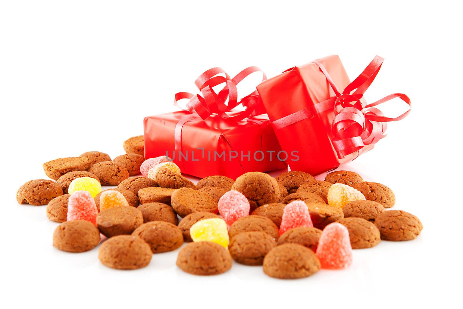 Typical dutch sweets: pepernoten (ginger nuts) and presents for celebration at 5 december in the Netherlands over white background